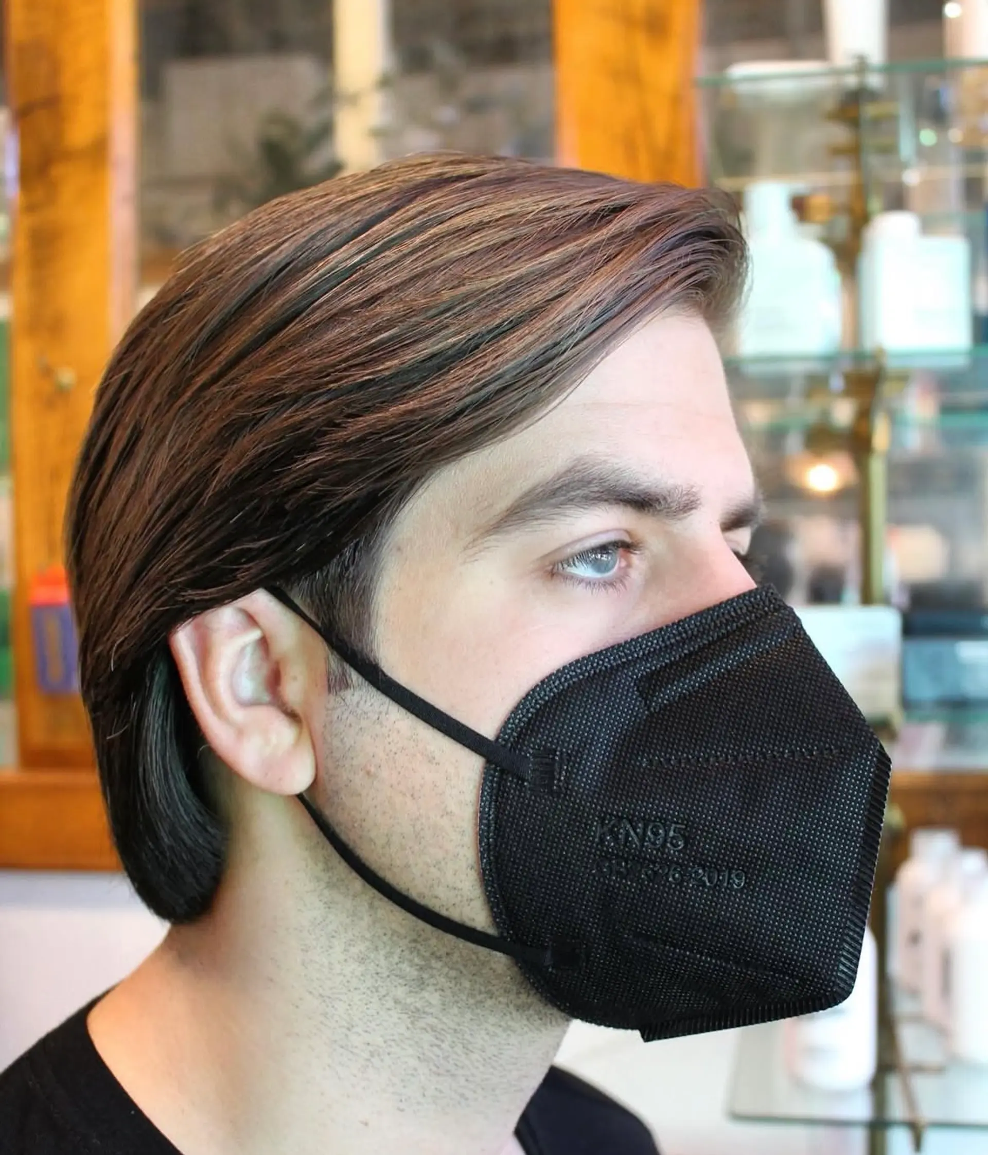 A slicked back hairstyle with medium length hair. 1