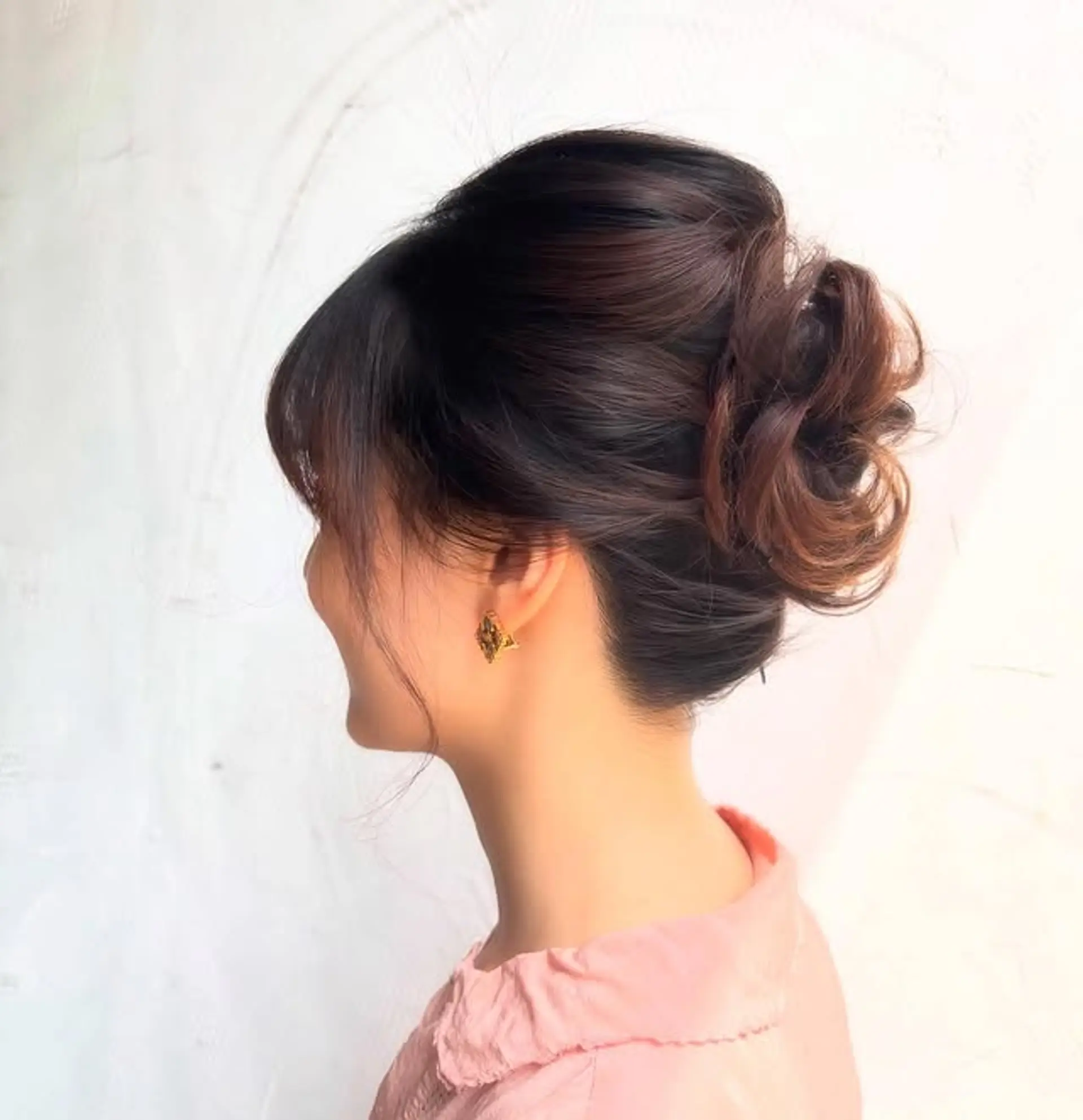 Elegant low bun with face-framing bangs. 1