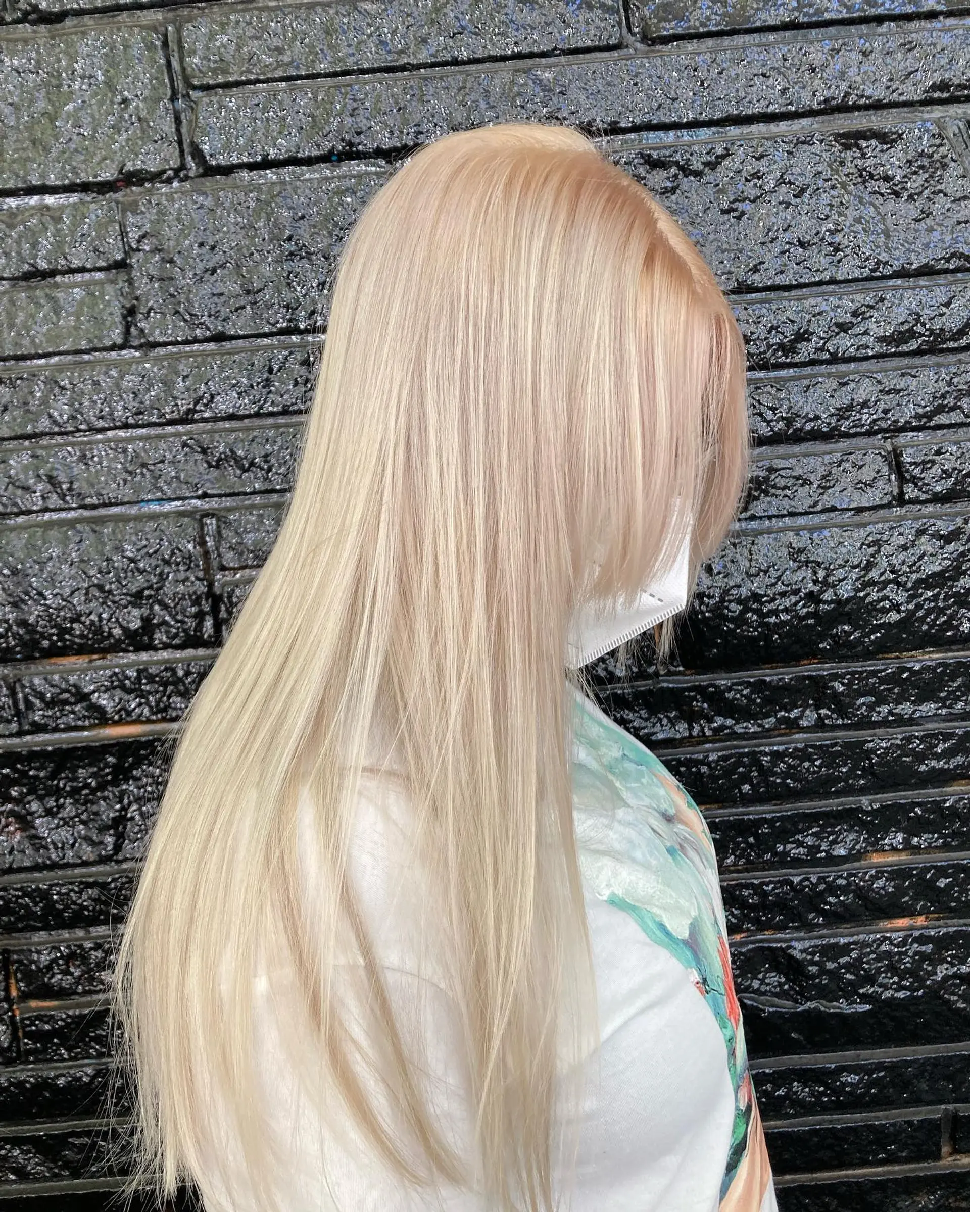Silky smooth, long straight hair colored in an ultra-light champagne and platinum blonde shade. 1