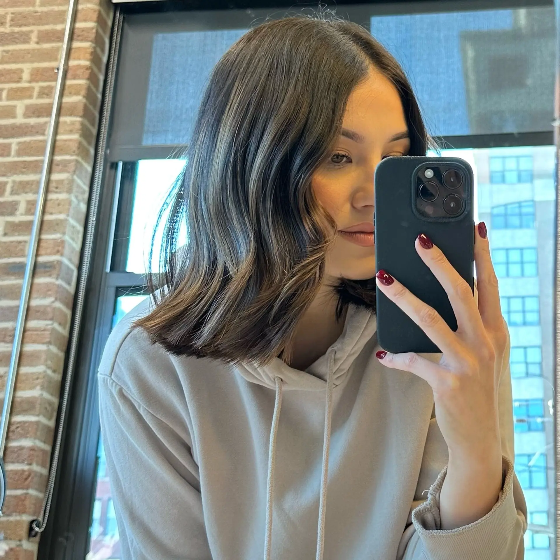 A stylish shoulder-length lob with soft waves and a bronde balayage. 1