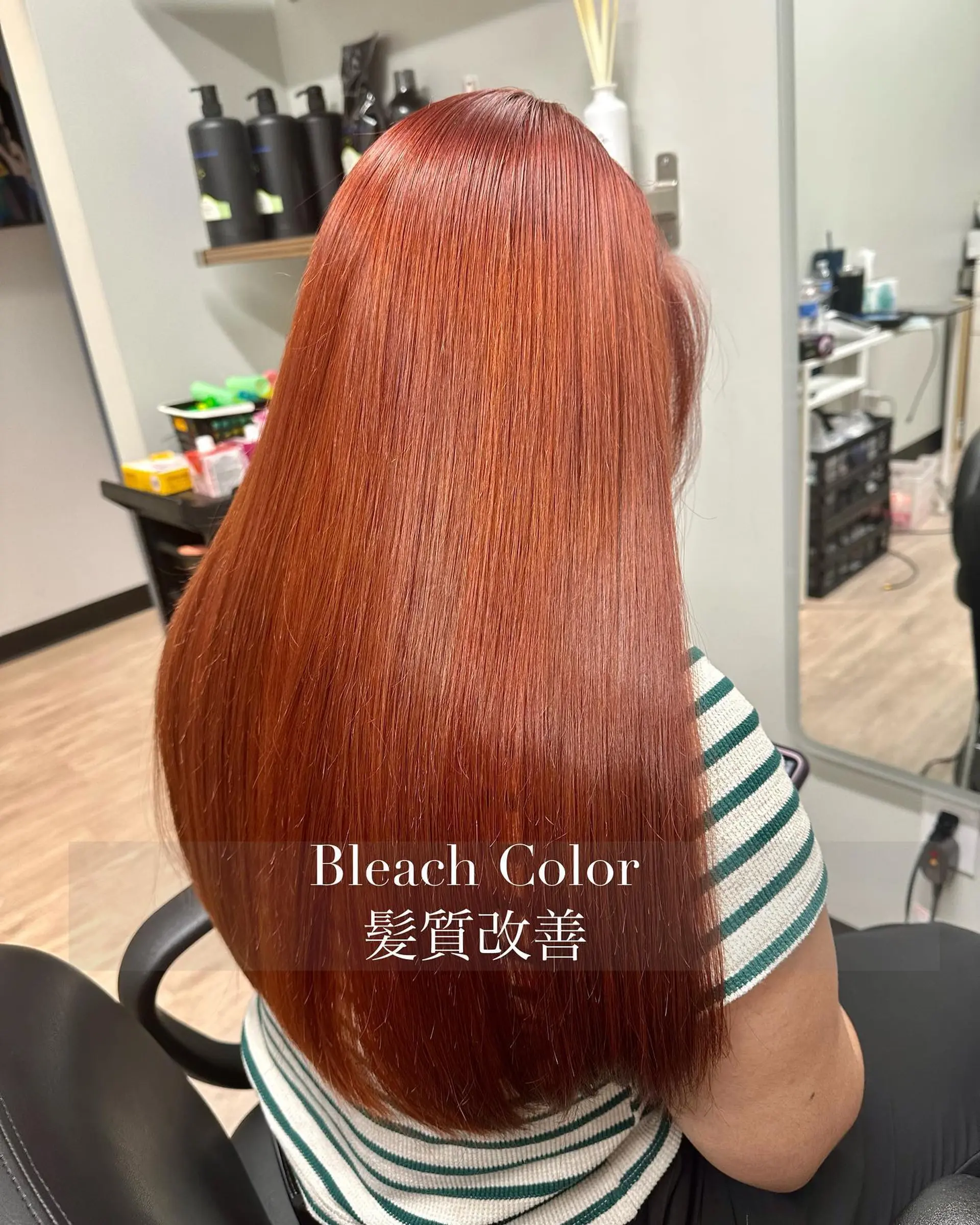 Long, ultra-sleek straight hair colored in a glossy, vibrant copper tone. 1