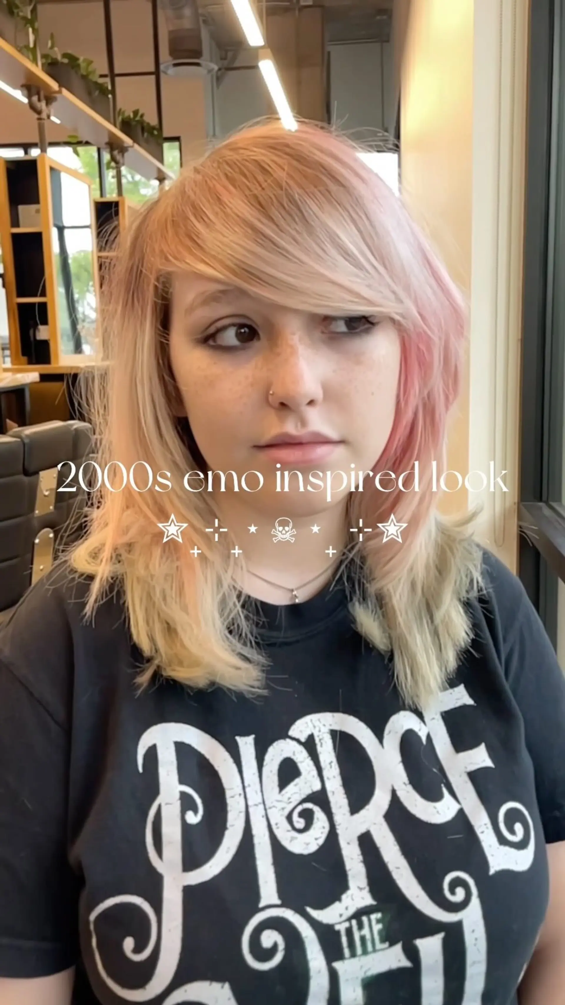 A 2000s-inspired emo scene hair style with dramatic side-swept bangs, choppy layers, and pastel pink color accents. 1