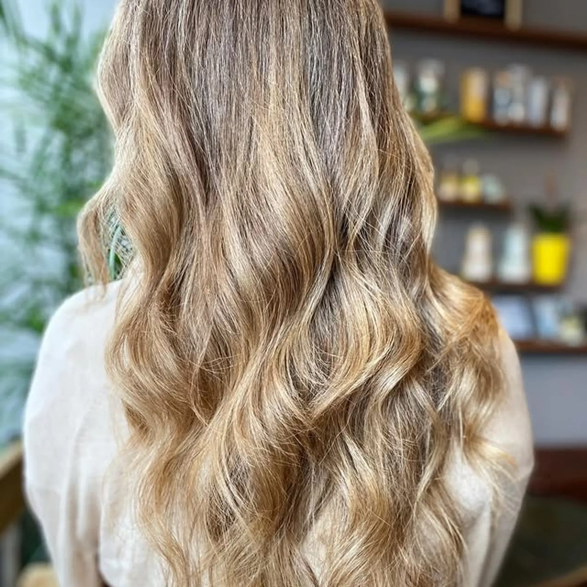 Long, wavy hairstyle with a balayage and layered haircut. 1
