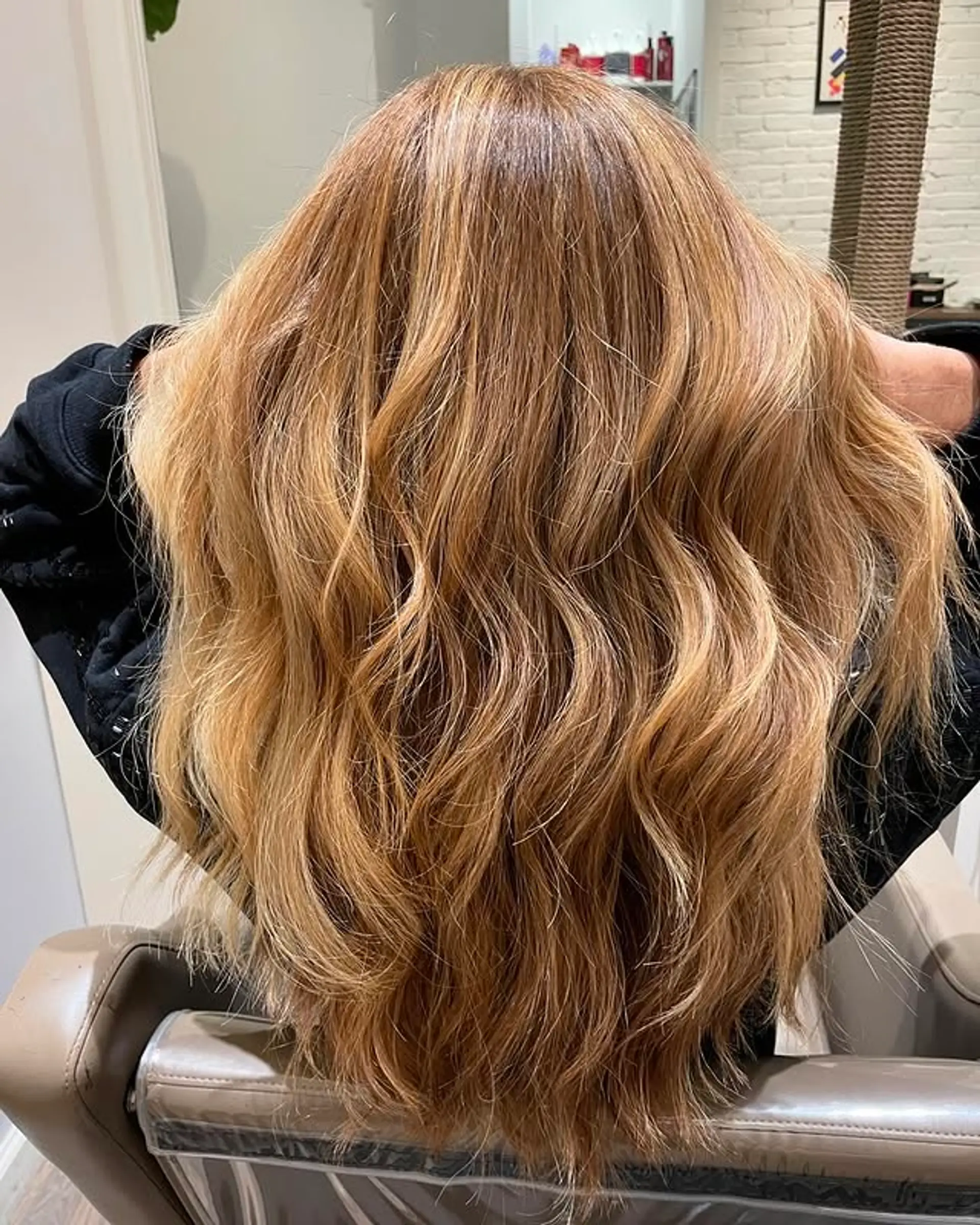 Long, wavy hairstyle with a bronde balayage and golden highlights. 1