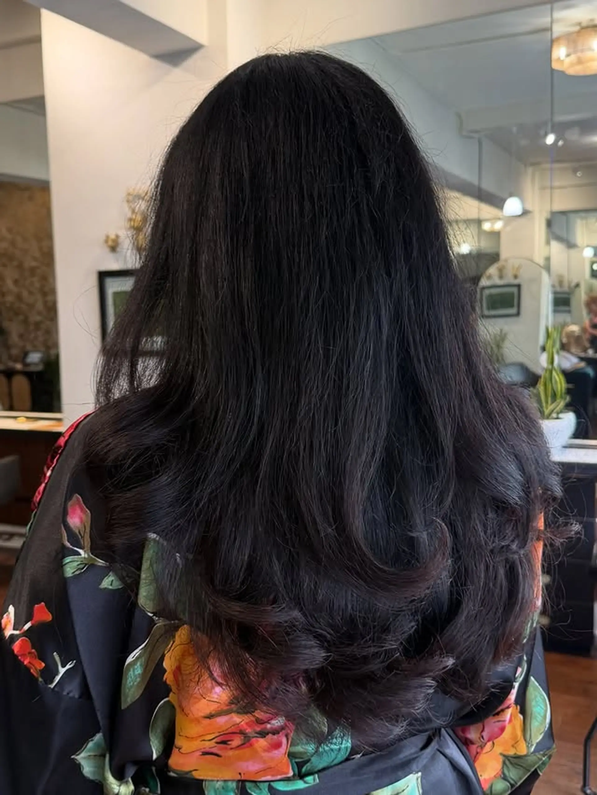 A long layered V-cut hairstyle with face-framing layers. 1