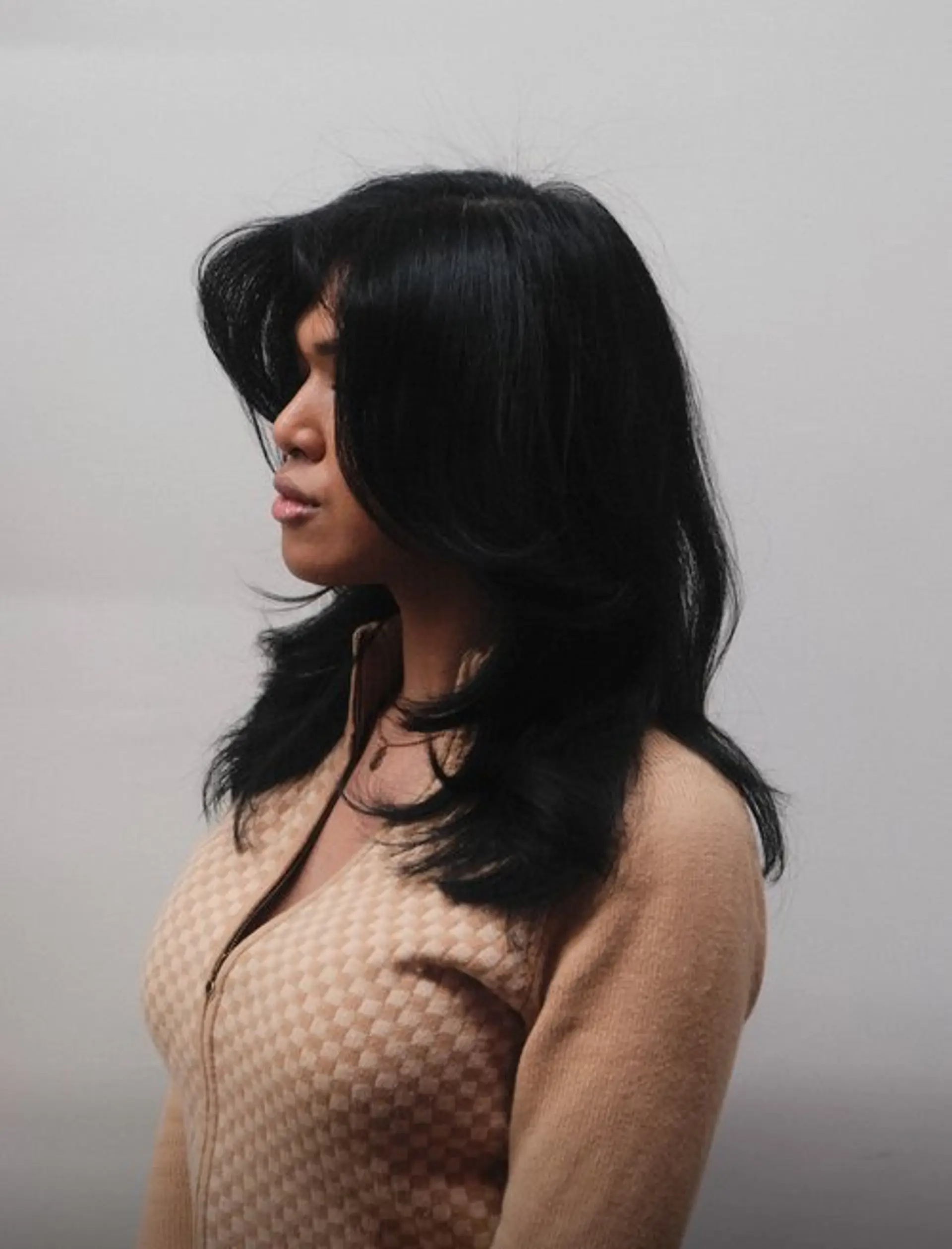 A medium-length layered hairstyle with a voluminous blowout. 1