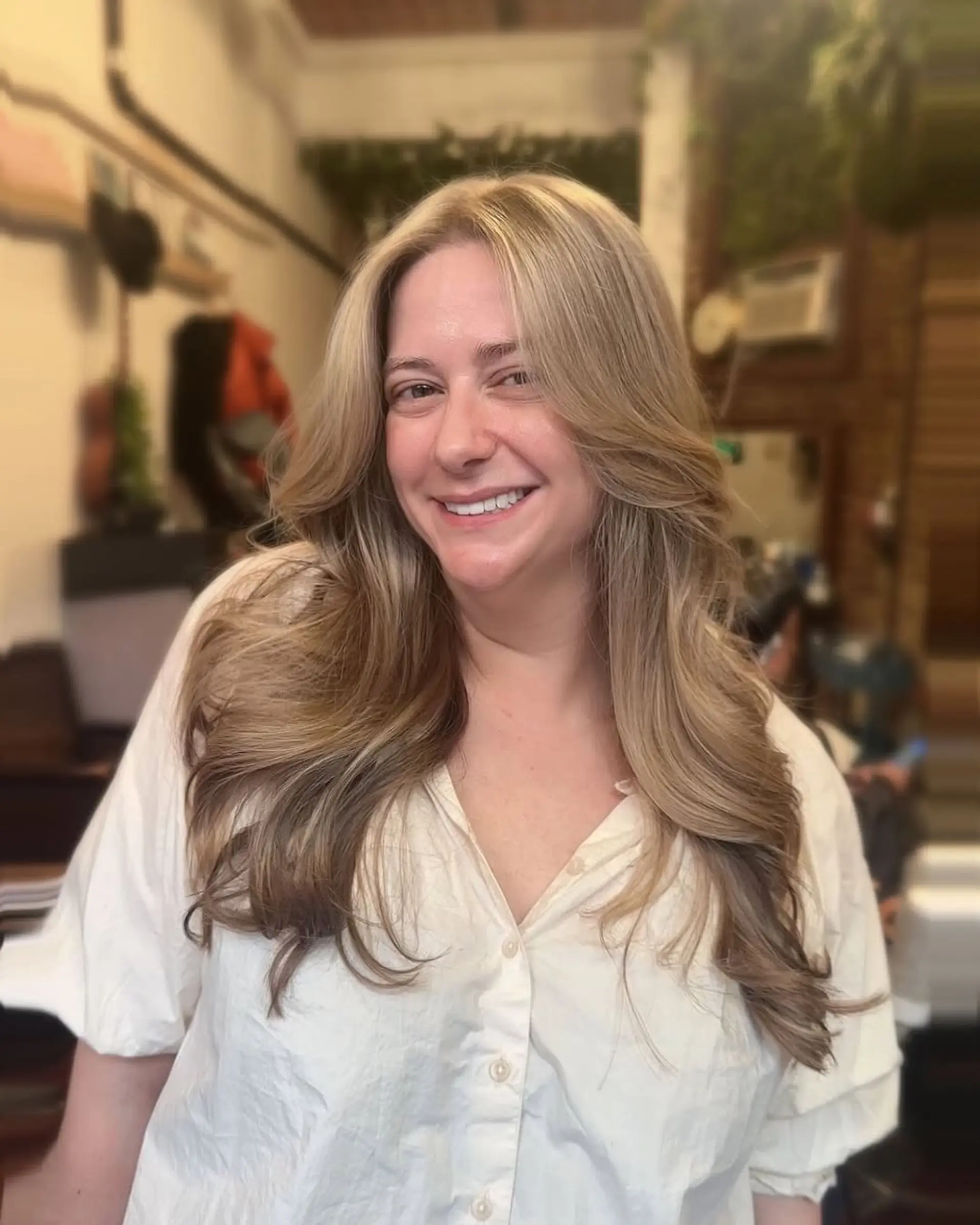 A long layered blowout with face framing highlights. 1