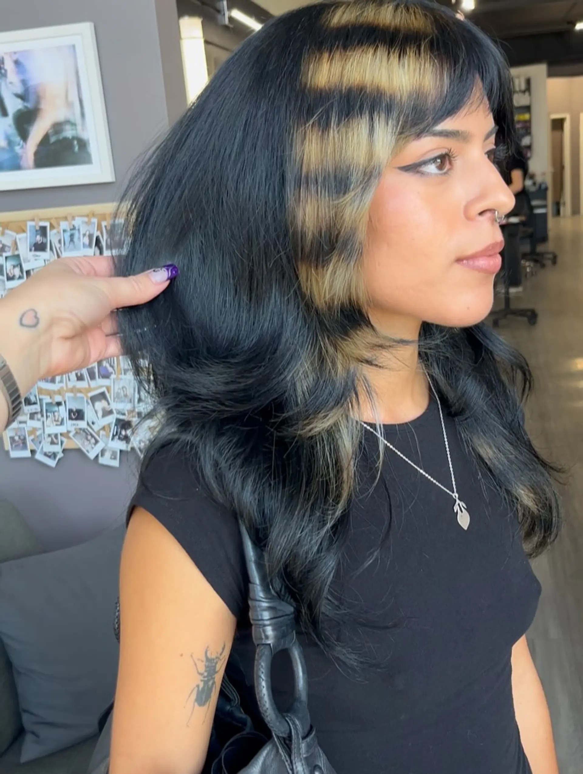 Layered black hair styled with soft volume, front fringe, and contrasting horizontal blonde raccoon tail stripes. 1