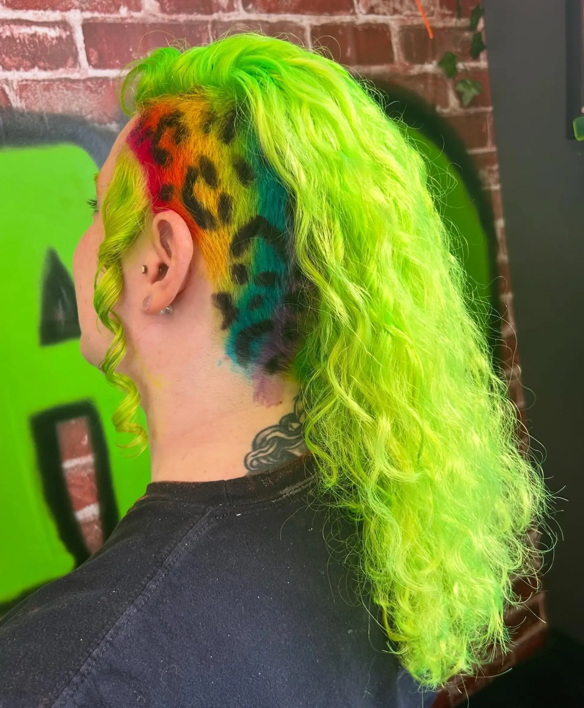 Vibrant neon lime green wavy locks paired with a shaved side featuring a multicolored rainbow leopard print design. 1