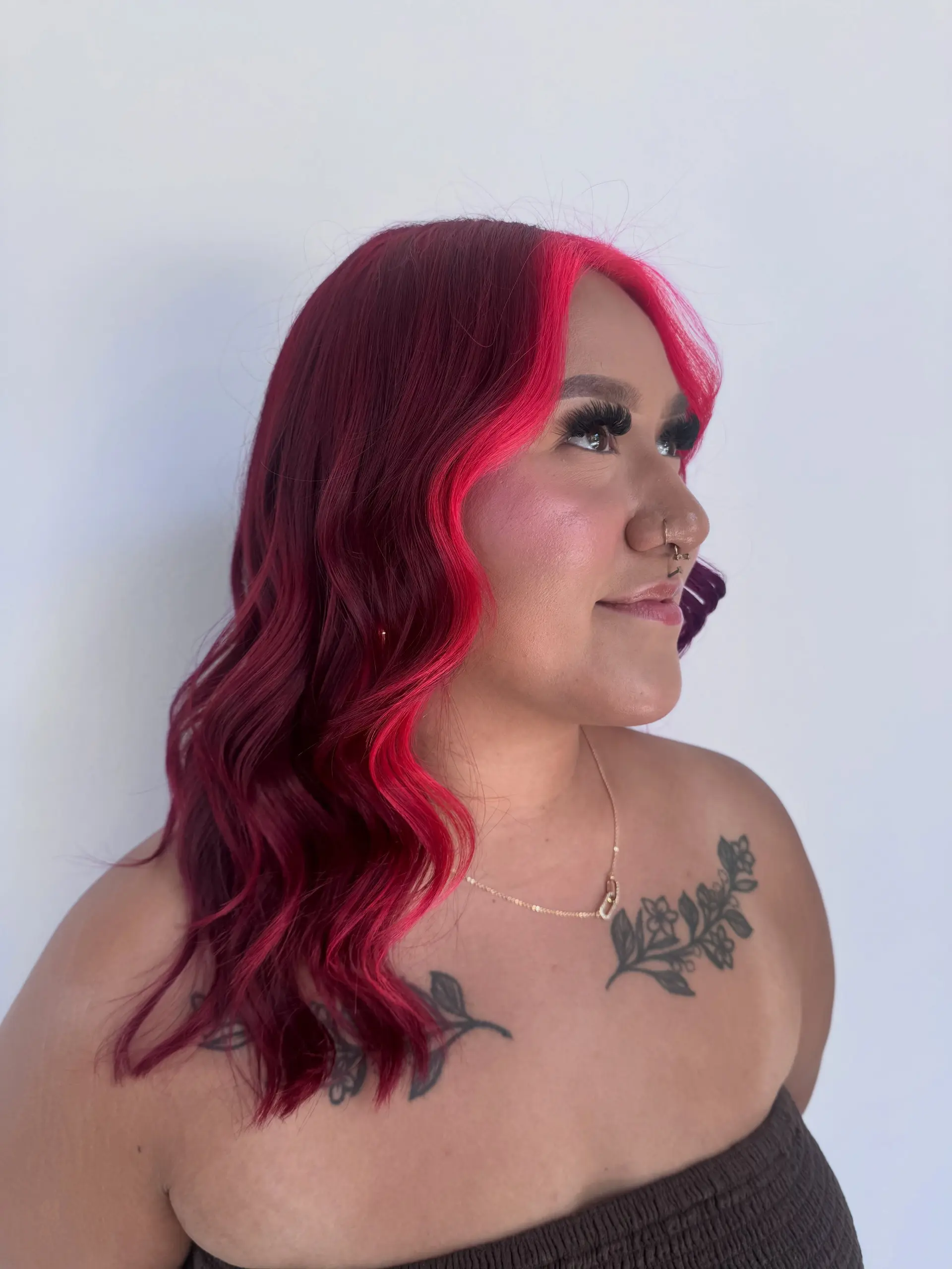A bold magenta-red base complemented by a vibrant hot pink money piece framing the face, styled in soft waves. 1
