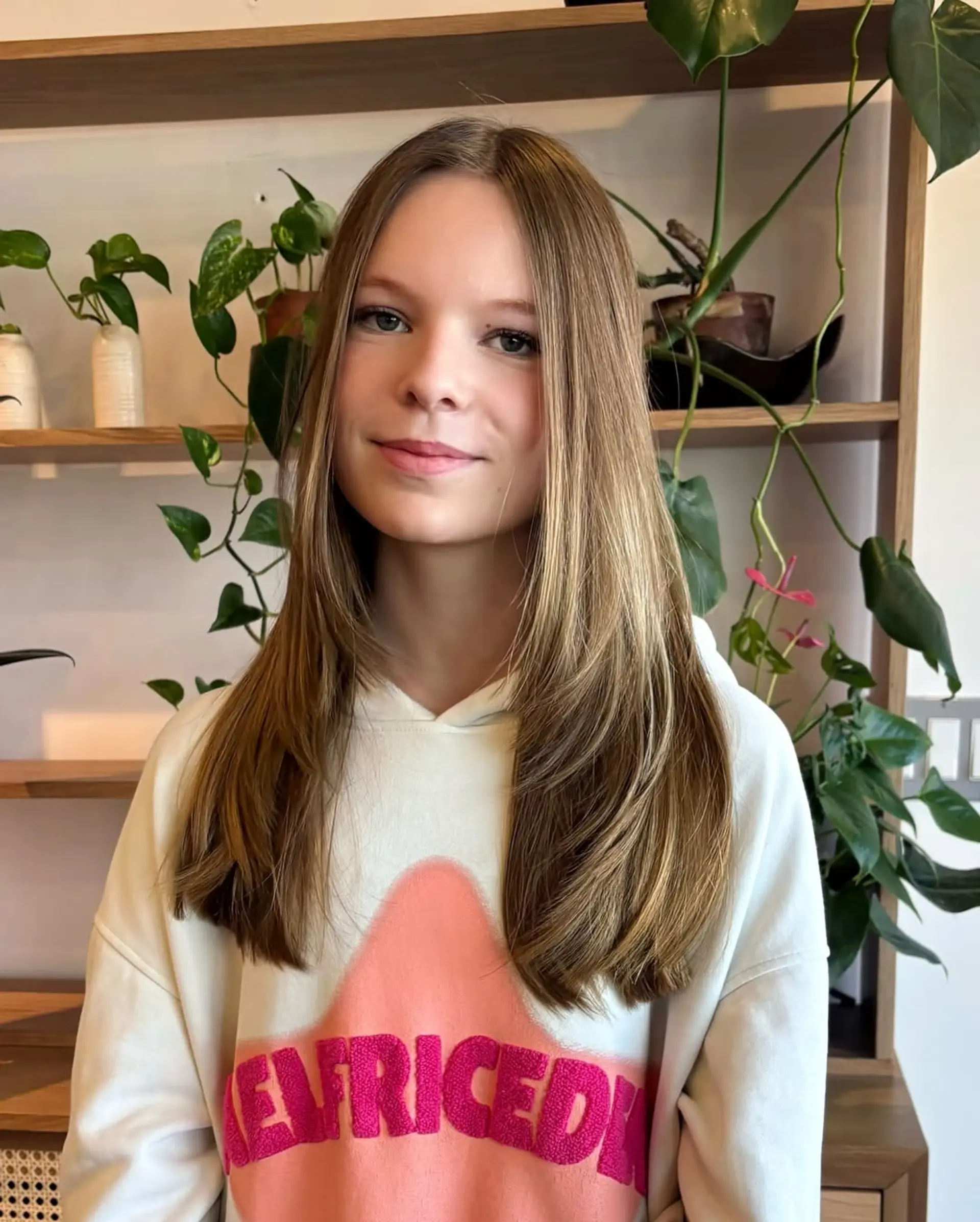 A medium-length, straight hairstyle with long, face-framing layers. 1