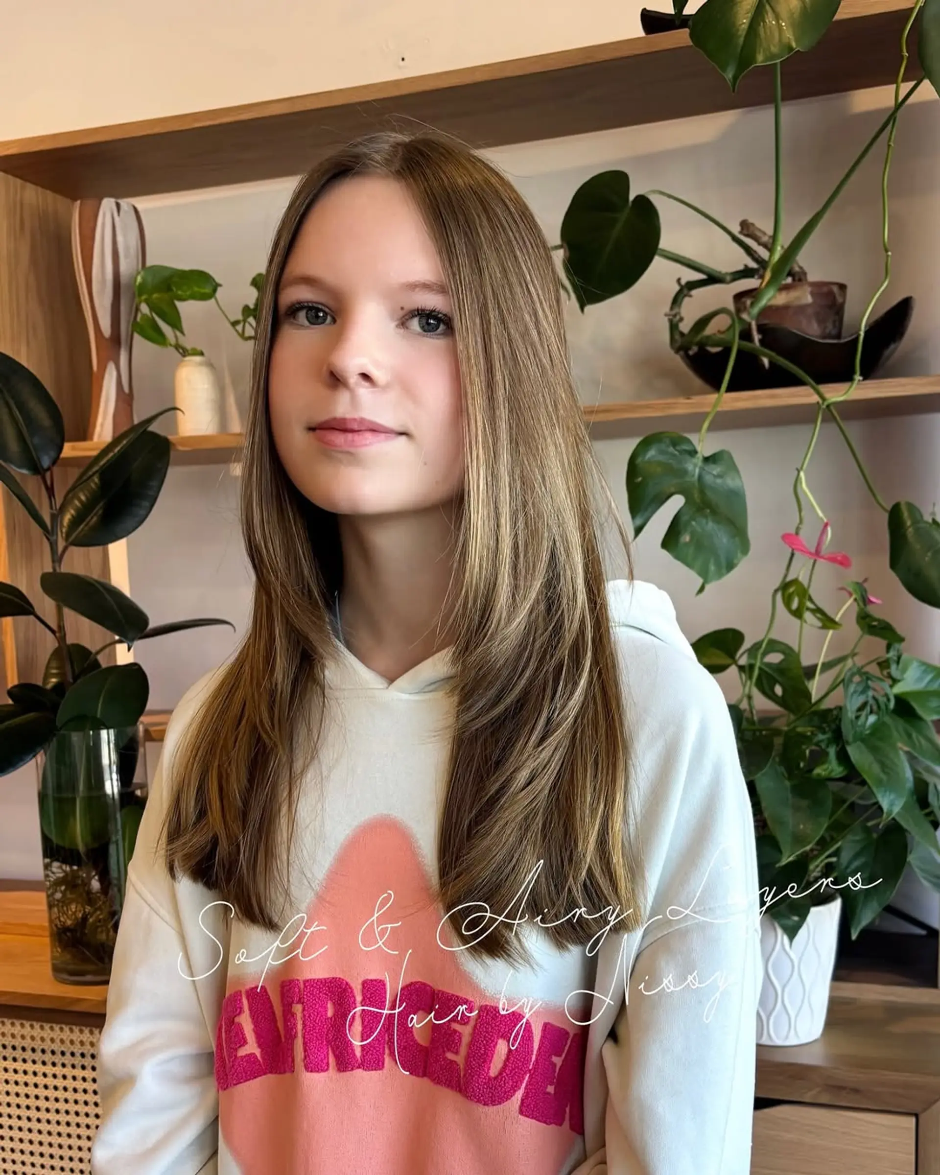 A medium-length, straight hairstyle with long, face-framing layers. 2