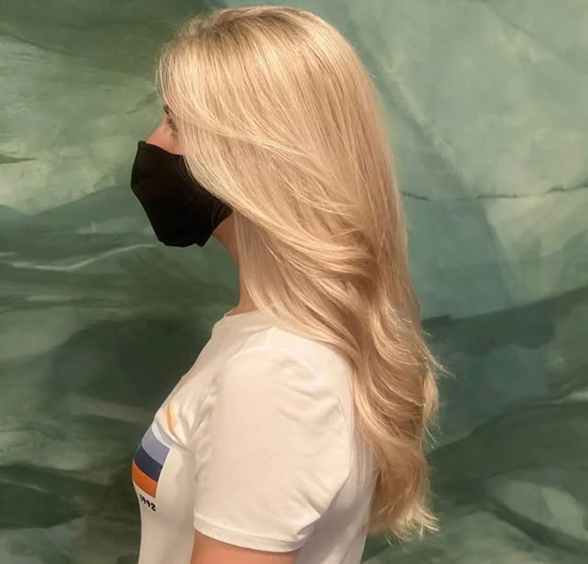 A model with a medium-length icy blonde shag haircut with Bardot bangs, a key trend for 2026. - Preview 2