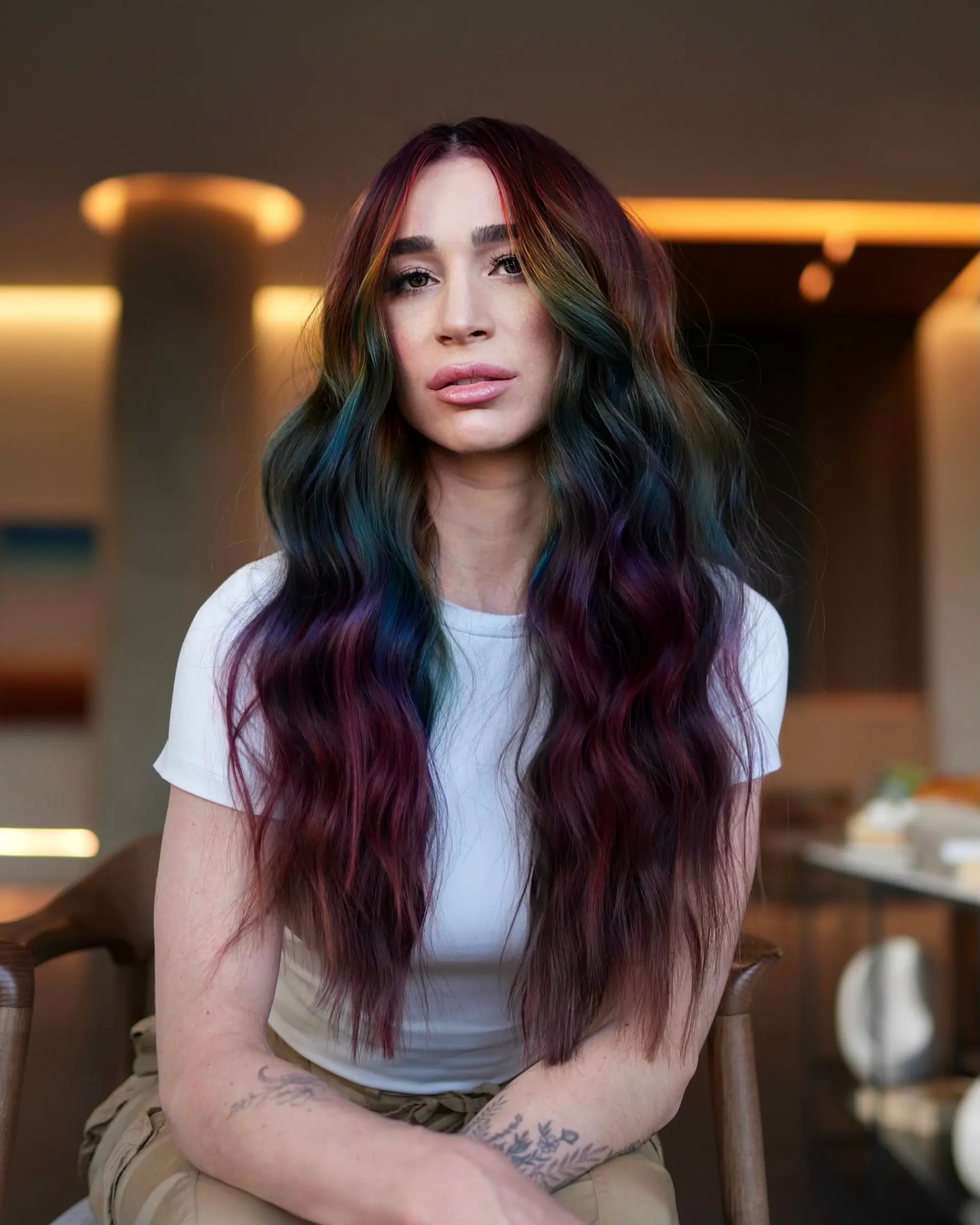 Long cascading waves featuring deep obsidian tones blended with vibrant rainbow jewel-toned ribbons. 1