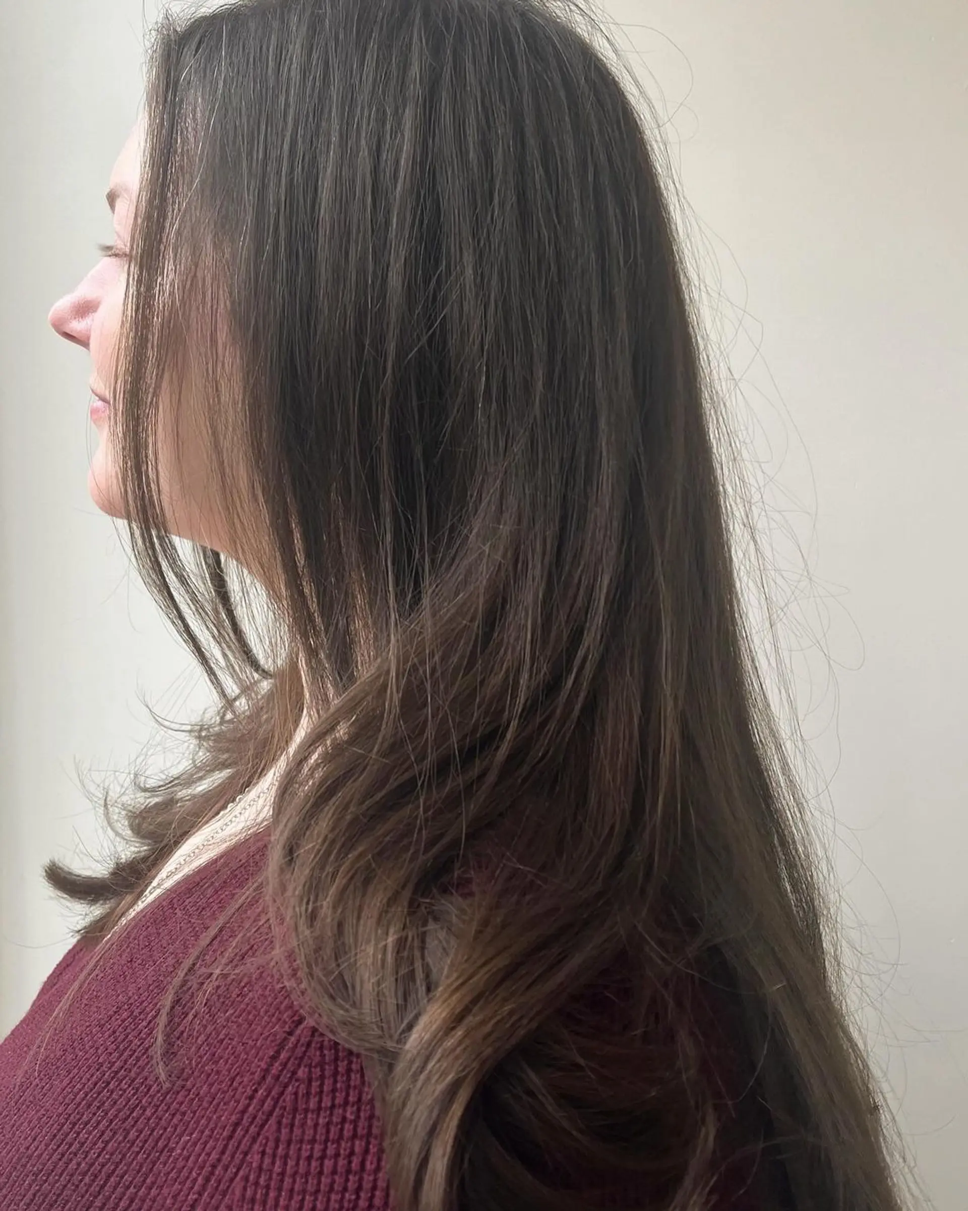 A long, layered style with face-framing layers, natural shine, and a soft under-curl. 2