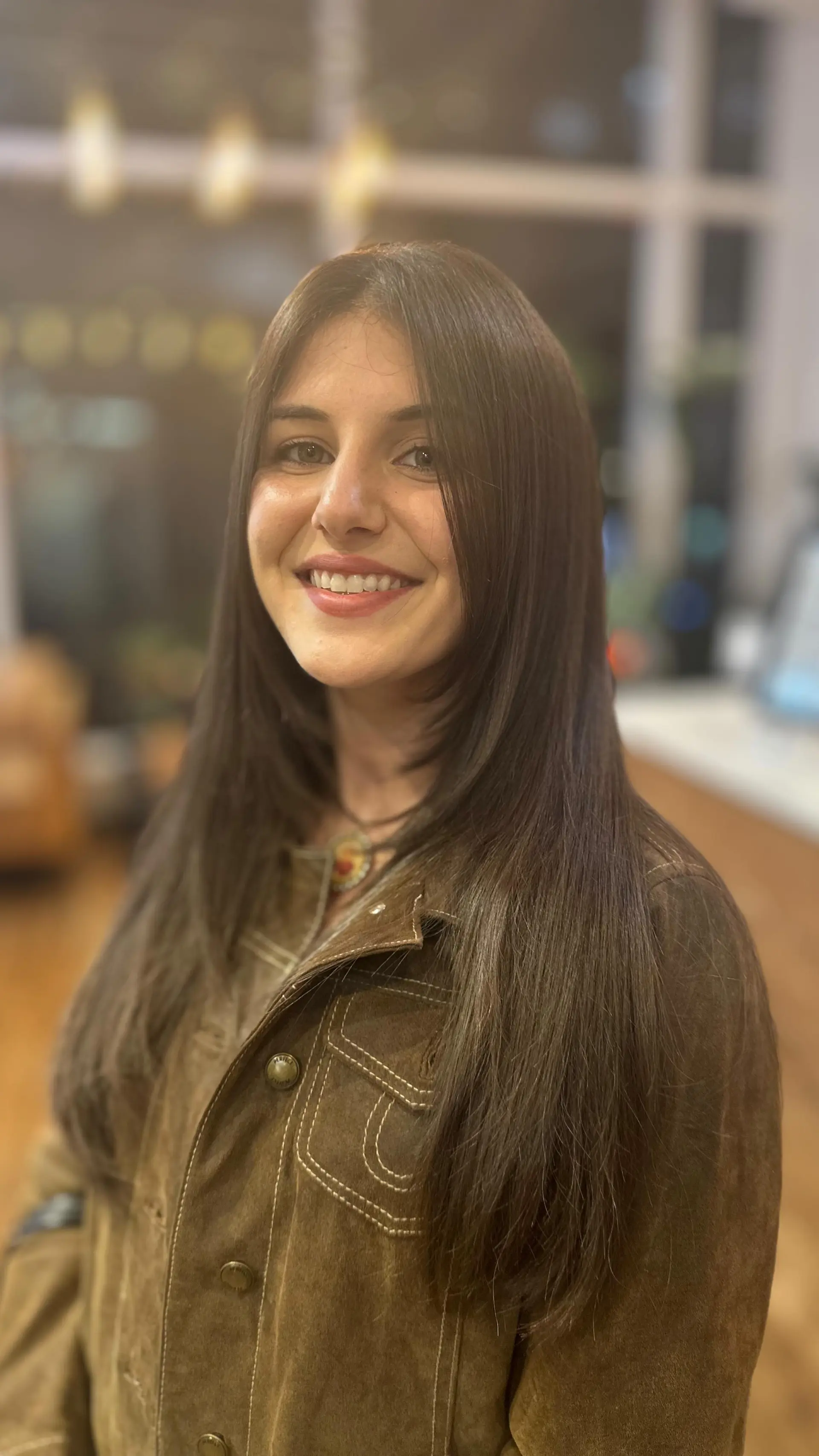 Long, sleek brunette hair featuring soft face-framing layers with a high-gloss, smooth finish. 1