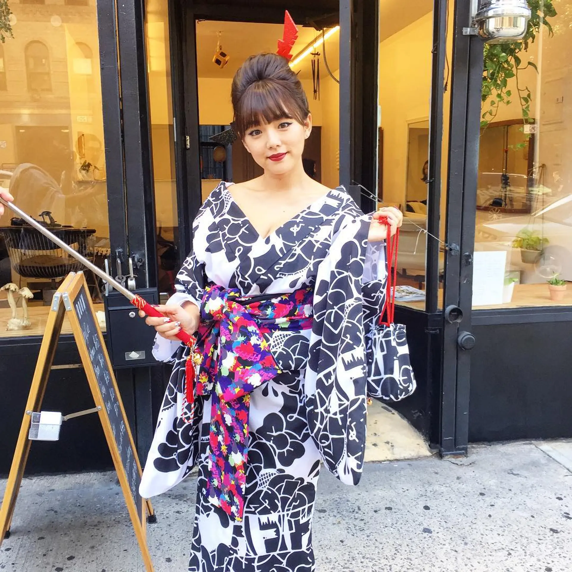An elegant, high updo with fringe bangs, accented by a hair stick accessory and traditional, polished styling. Styling by @takeohair for @shinopp._.ai 1