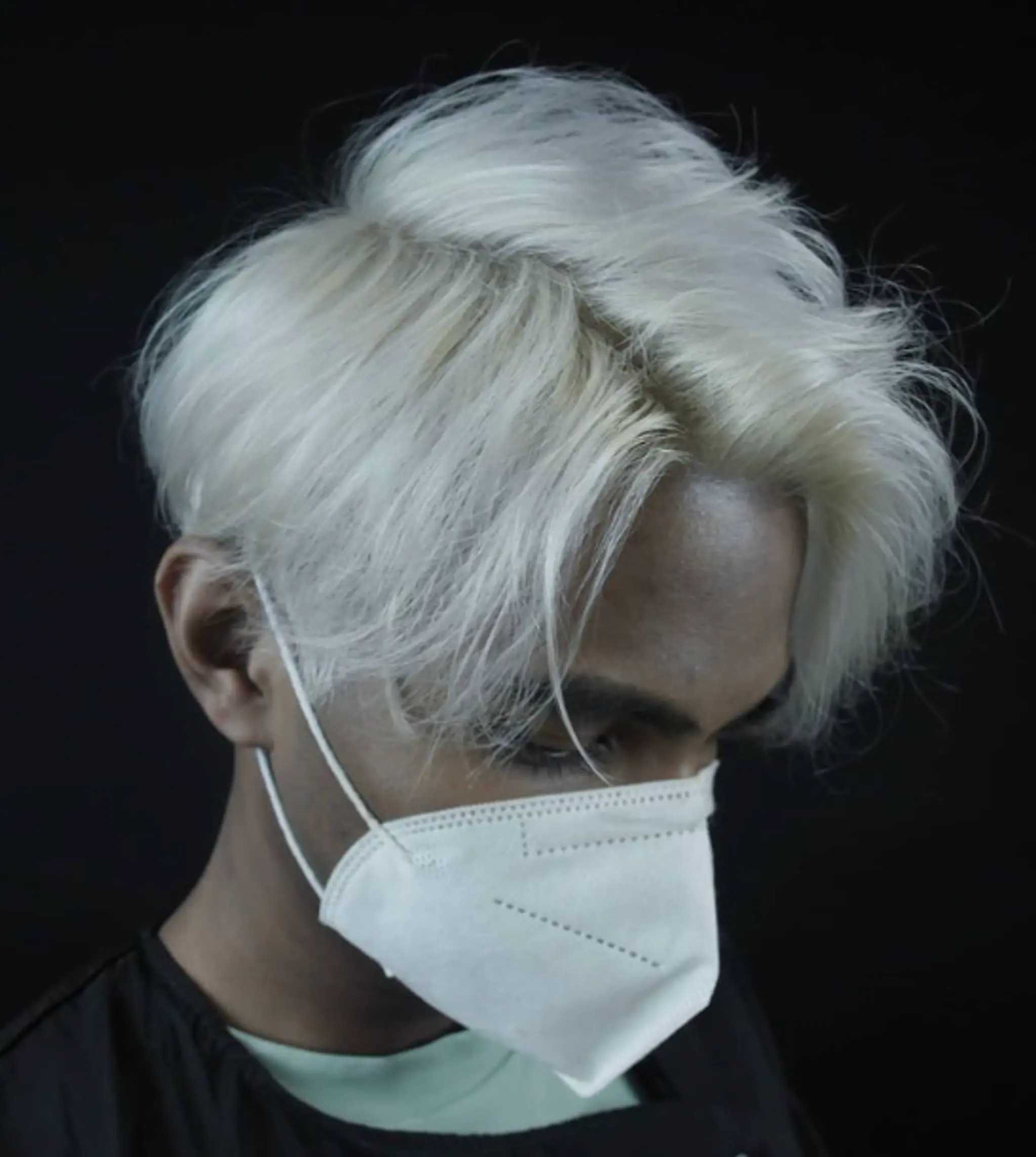 Medium length, straight hair with a voluminous, swept-back style, featuring silver and platinum blonde colors with a layered fringe.