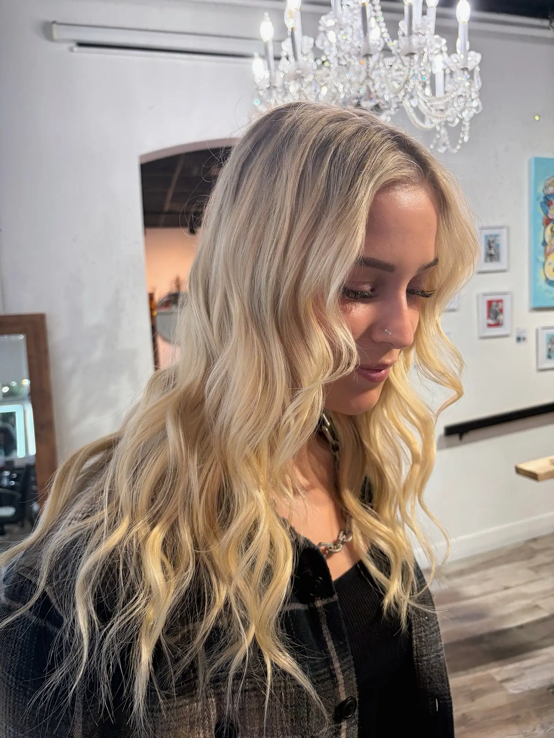 Long, luminous blonde hair styled in effortless, relaxed waves with soft face-framing layers. 1
