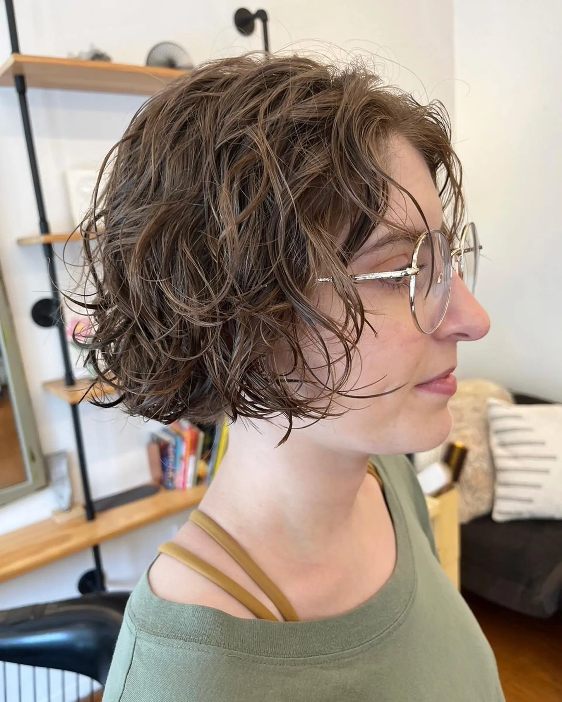 A short, light brown wavy bob with layers creating a tousled, textured look. Perm and Hair cut by @limi.nyc 3