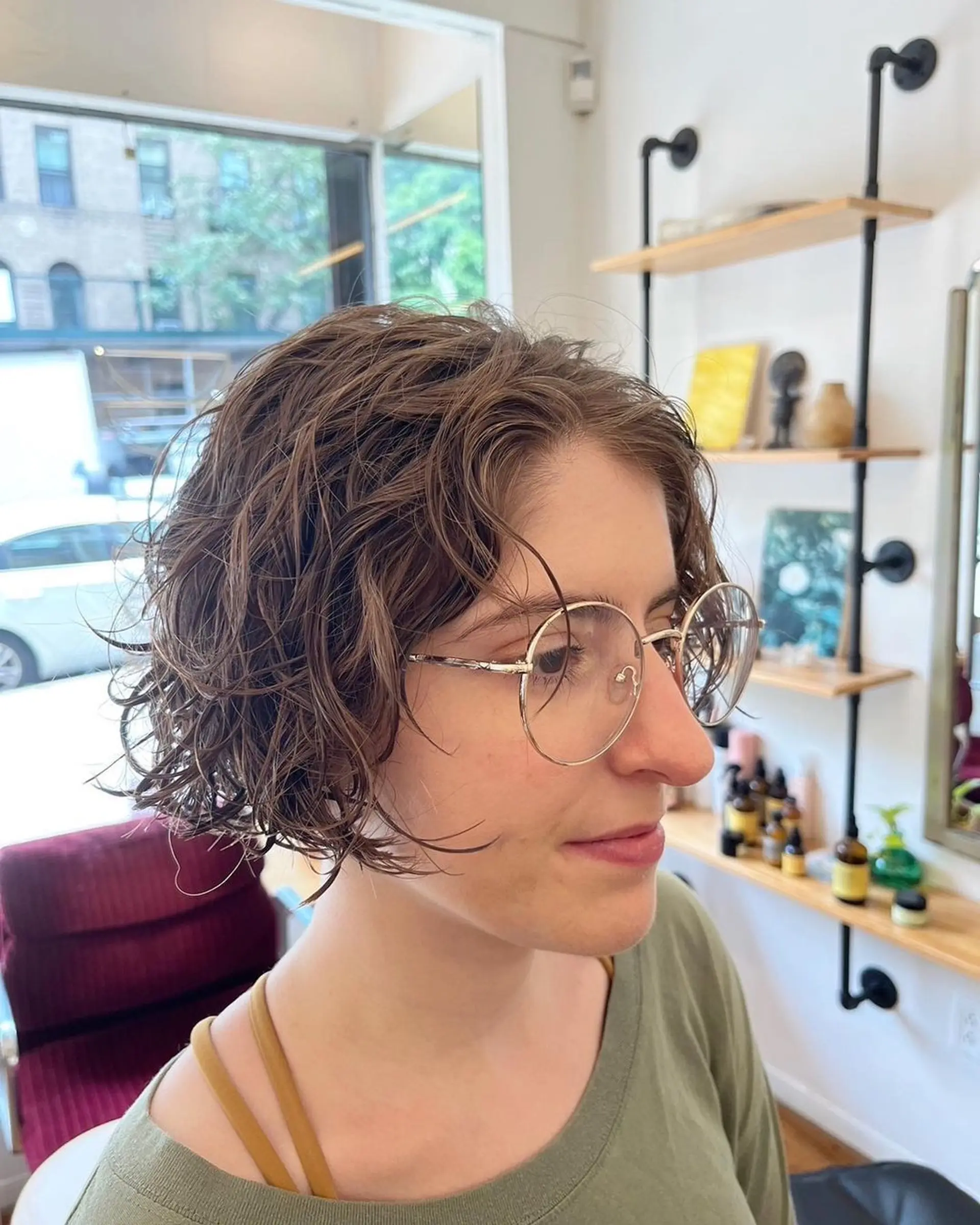 A short, light brown wavy bob with layers creating a tousled, textured look. Perm and Hair cut by @limi.nyc 2