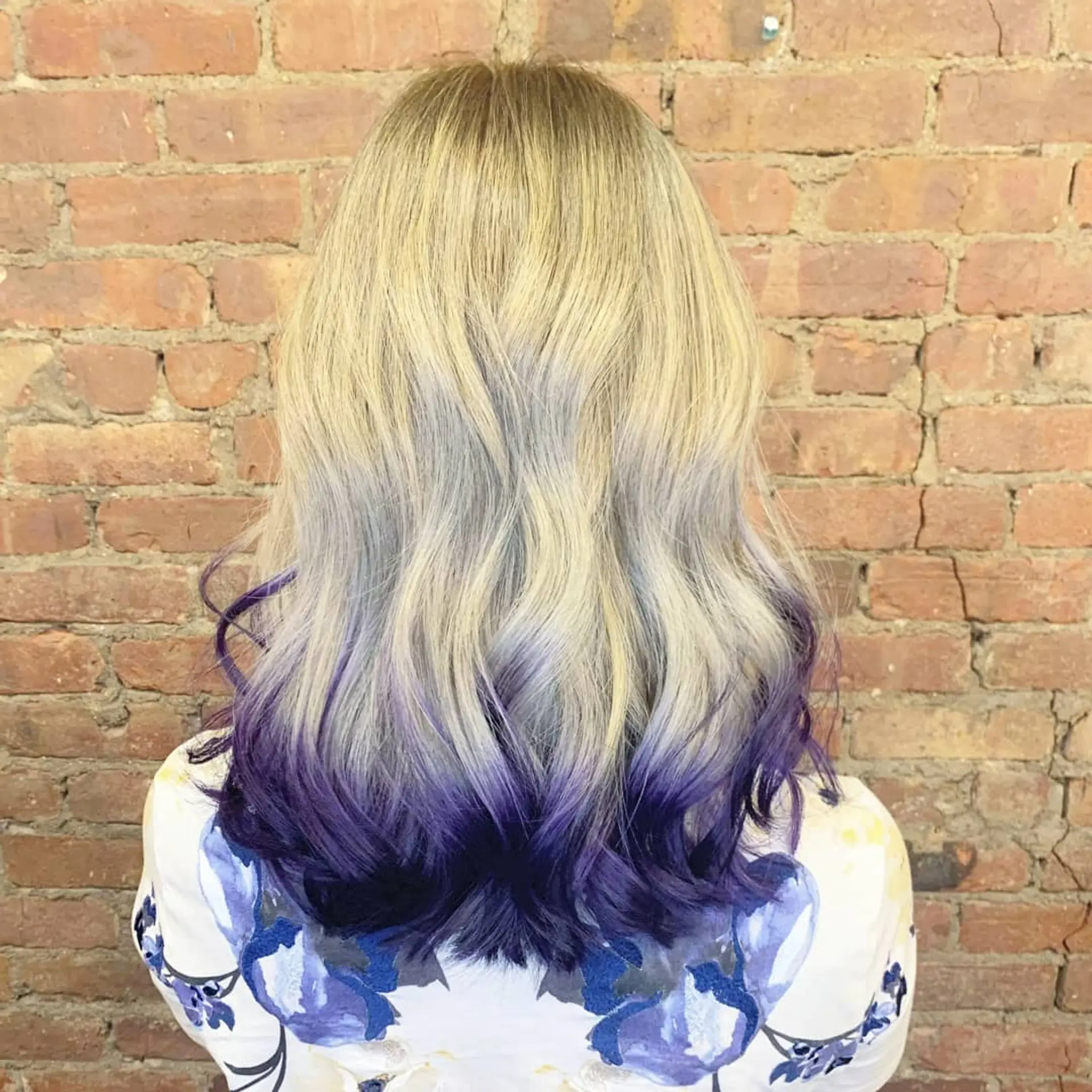 Medium-length blonde hair styled in soft waves featuring vibrant violet-purple dip-dyed ends. 1