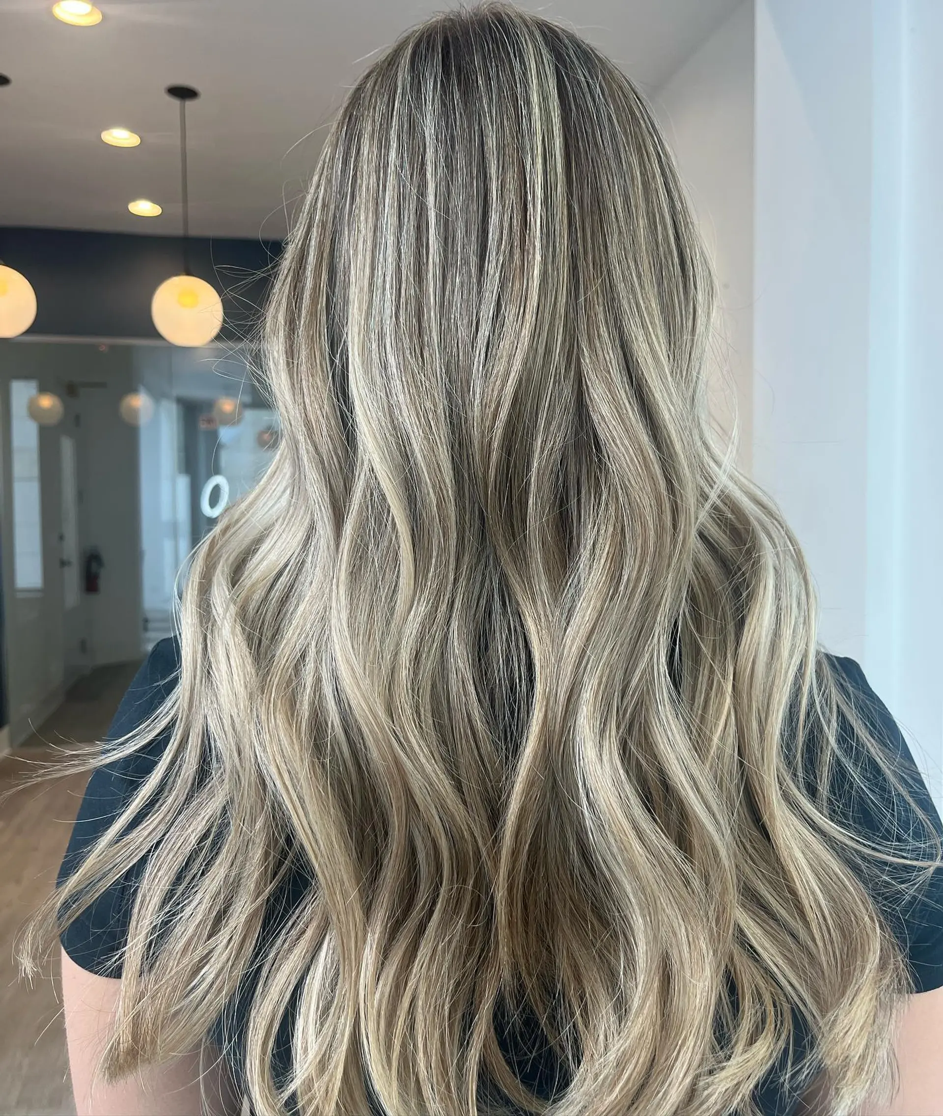 Long hair styled with beachy waves and a blonde balayage. 1