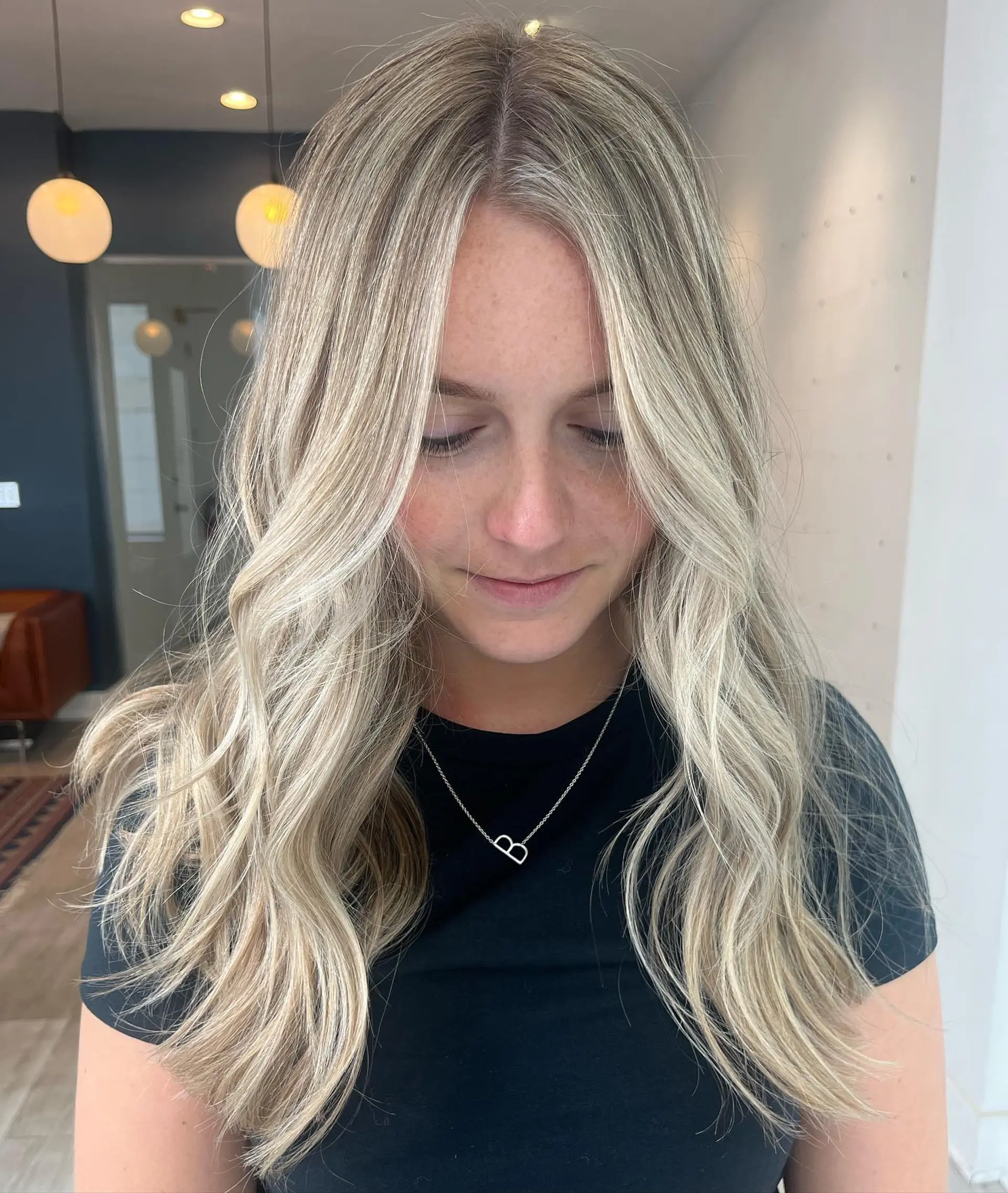 Long hair styled with beachy waves and a blonde balayage. 2