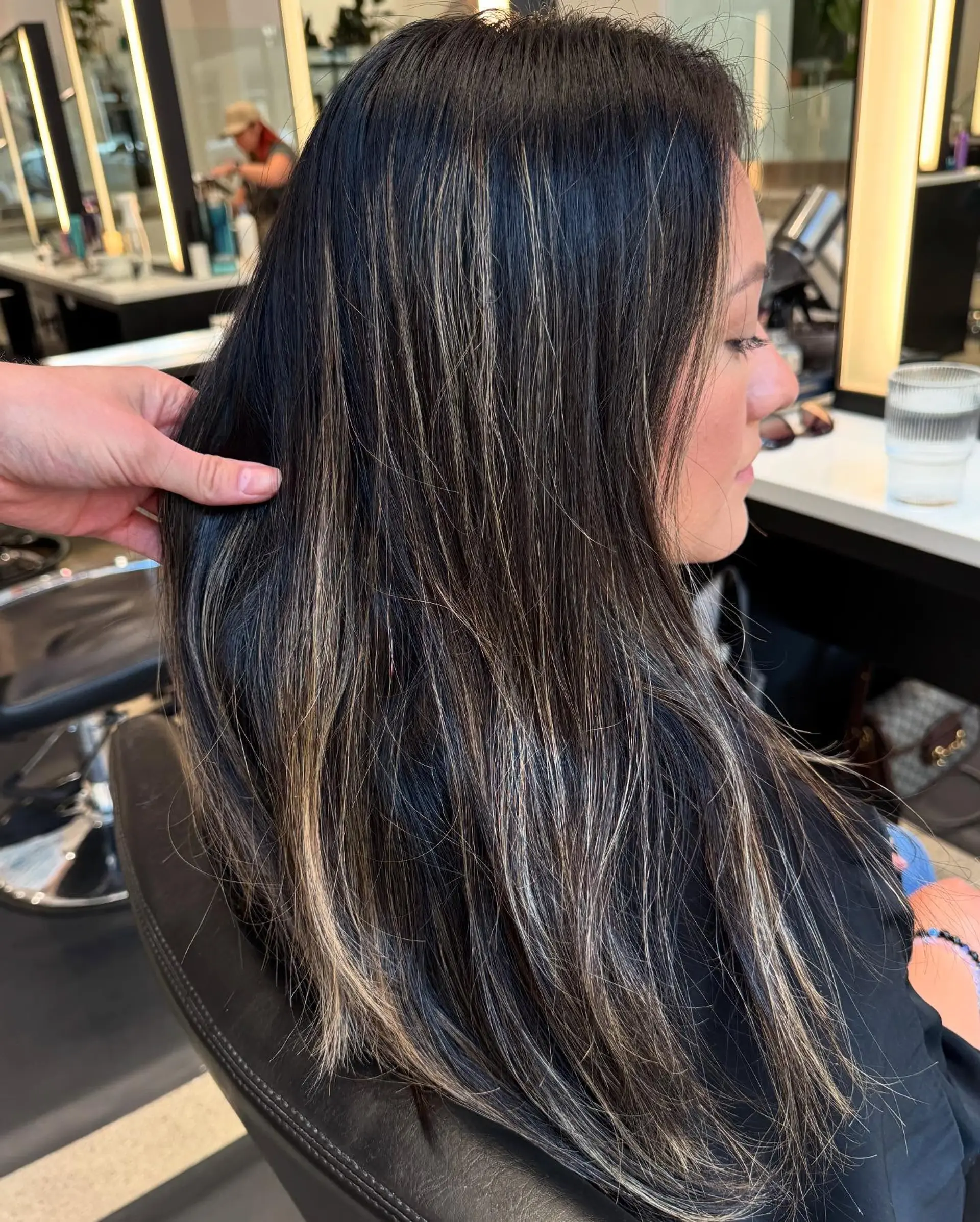 A medium-length wavy hairstyle with a blended bronzed balayage. 3