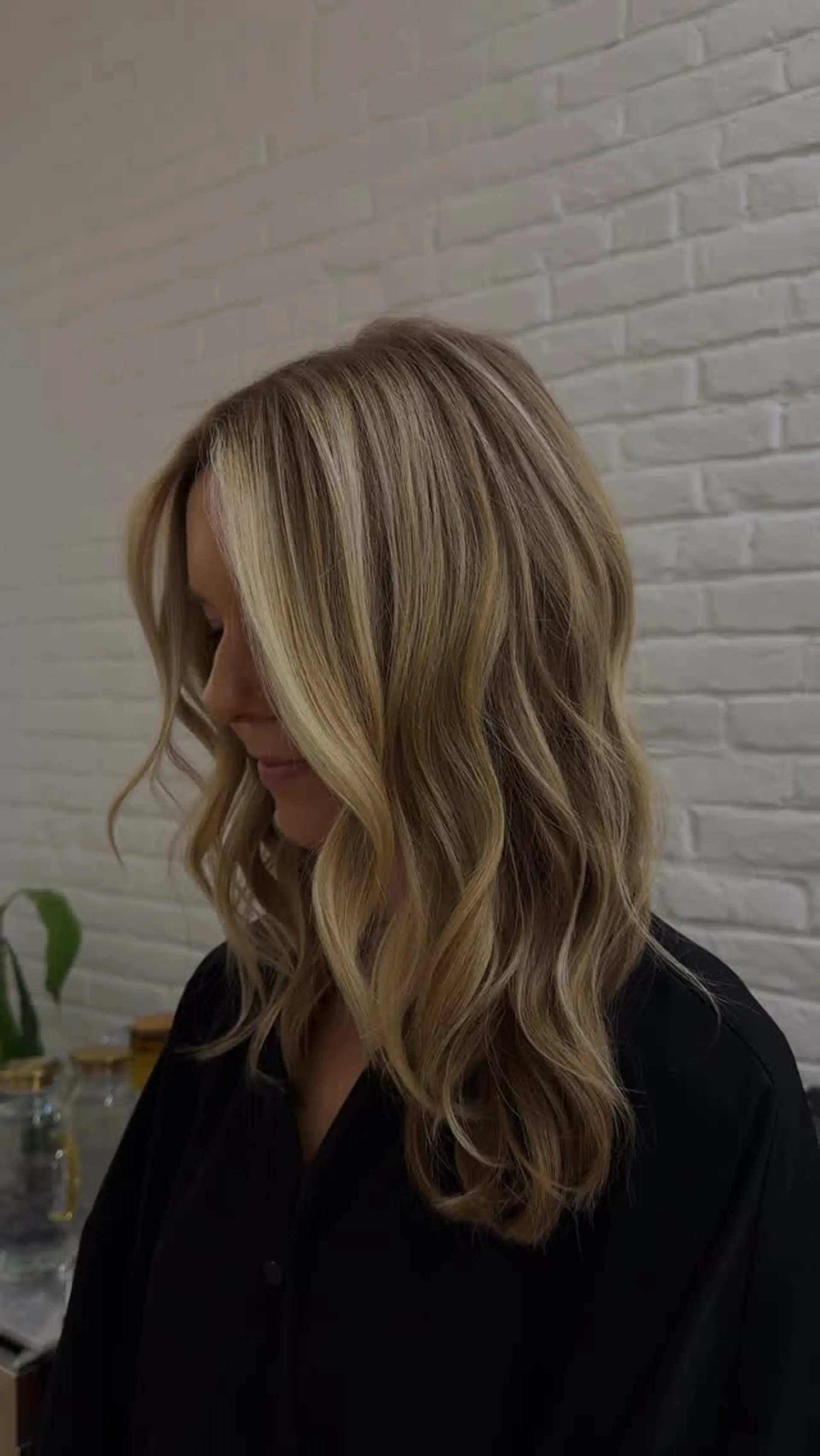 Long dimensional blonde hair styled in relaxed, loose waves with bright face-framing highlights. 1
