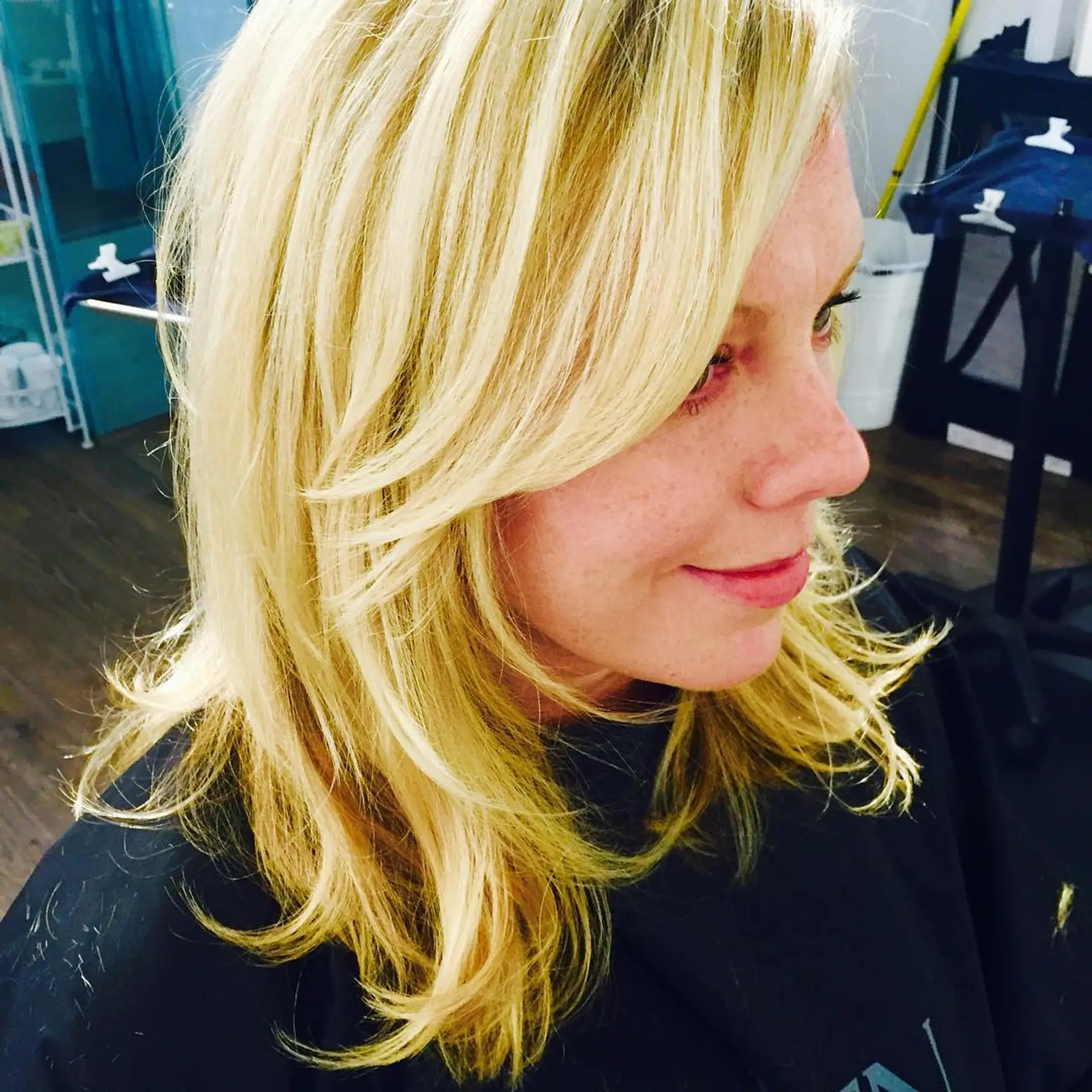 Medium-length golden blonde hair styled with face-framing layers and soft, textured flips. 1