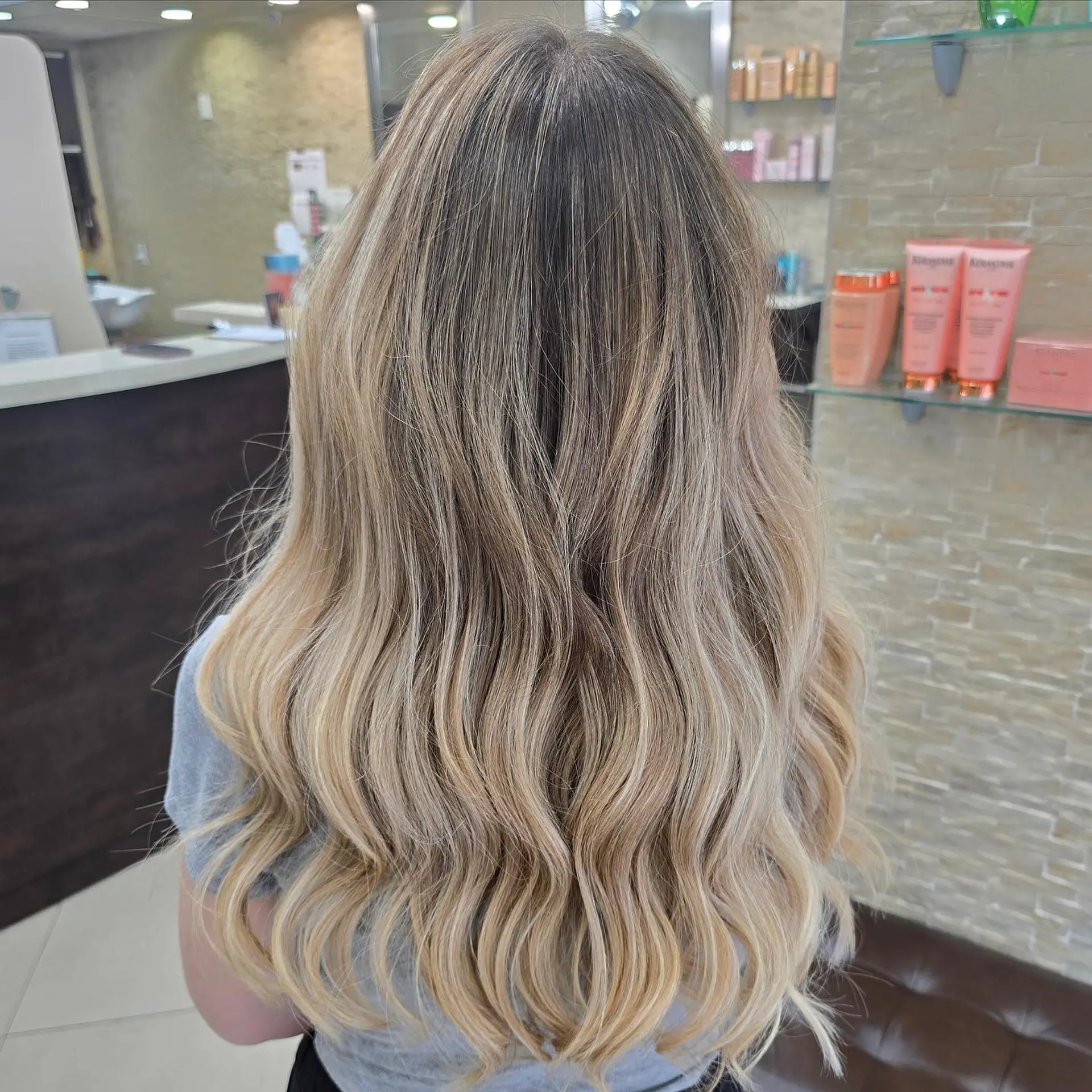 Long, wavy hair with a beautiful sandy blonde balayage and ombre effect. 1