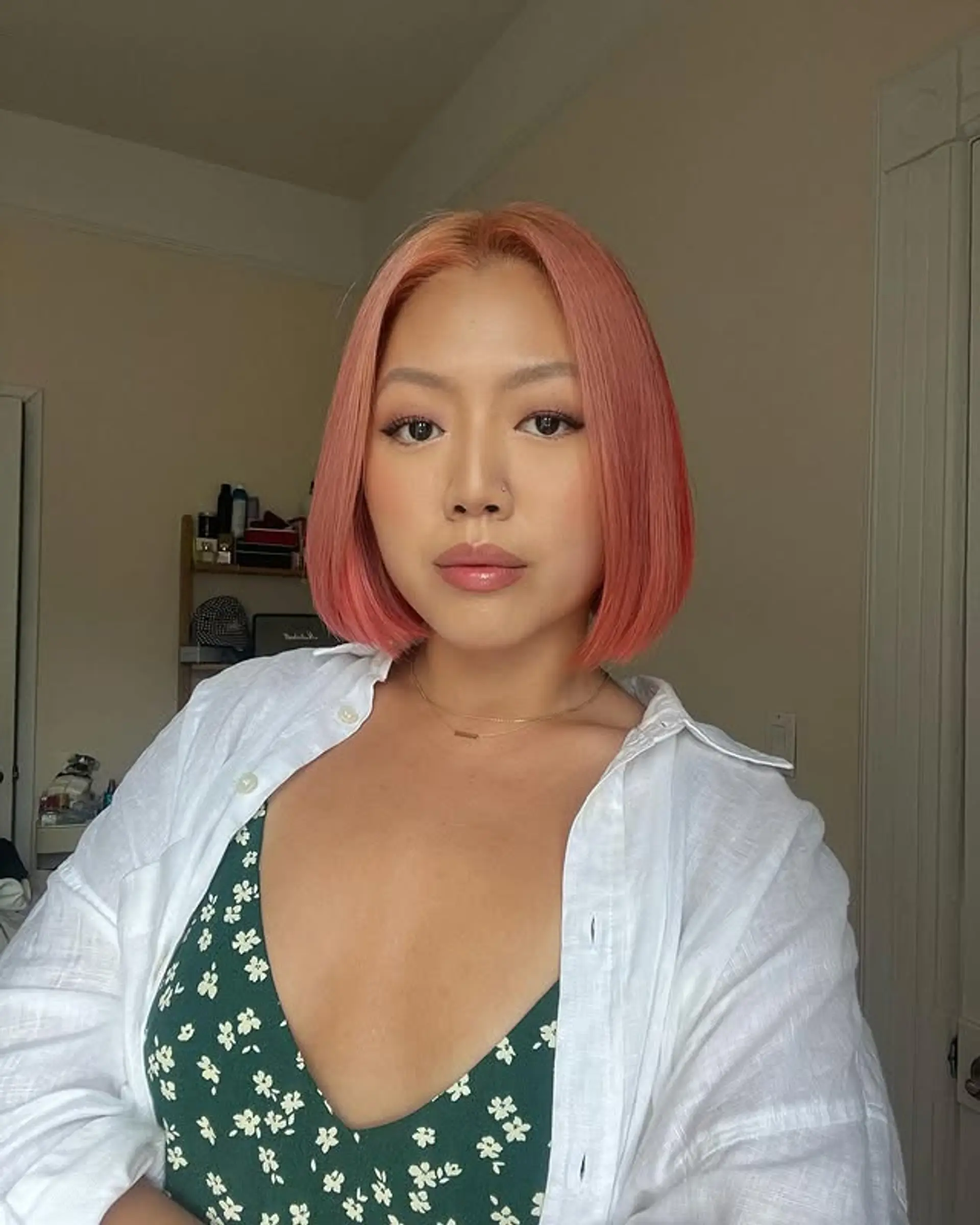 A chic blunt bob with a vibrant pastel coral color. 1