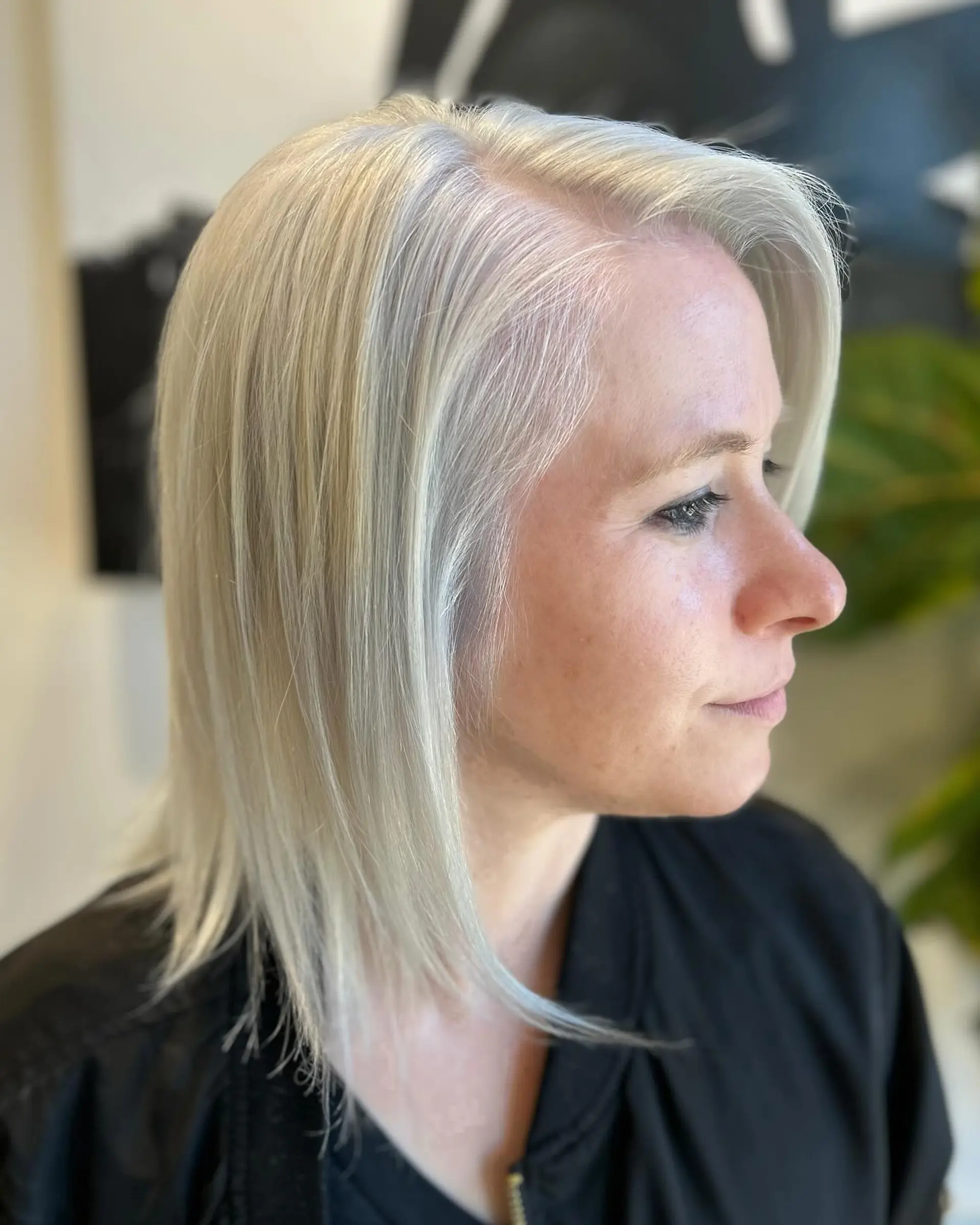 A sleek, bright platinum blonde lob styled straight with soft movement at the ends. 1