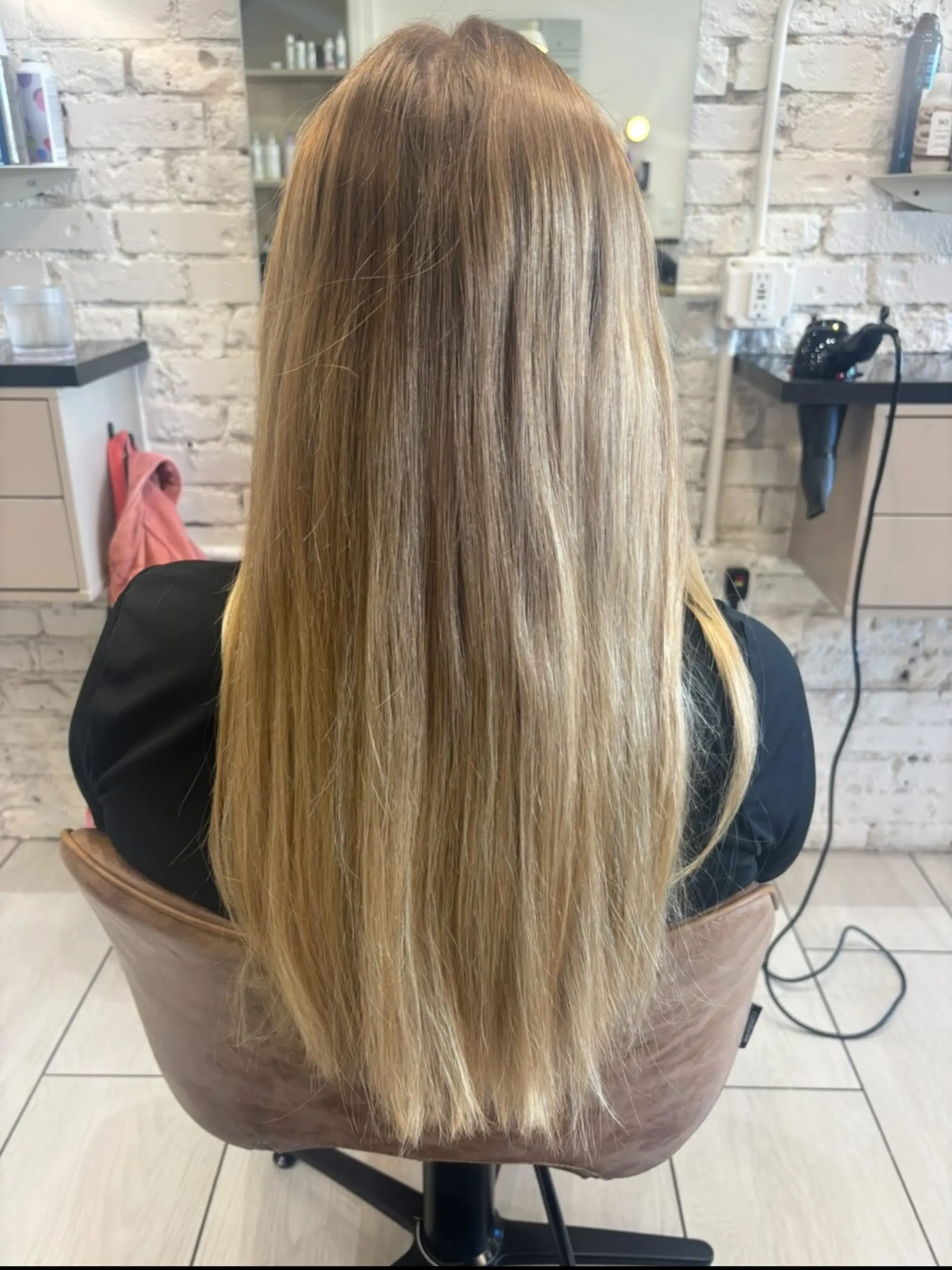 Long, sleek straight hair showcasing a blend of warm golden and honey blonde tones. 1