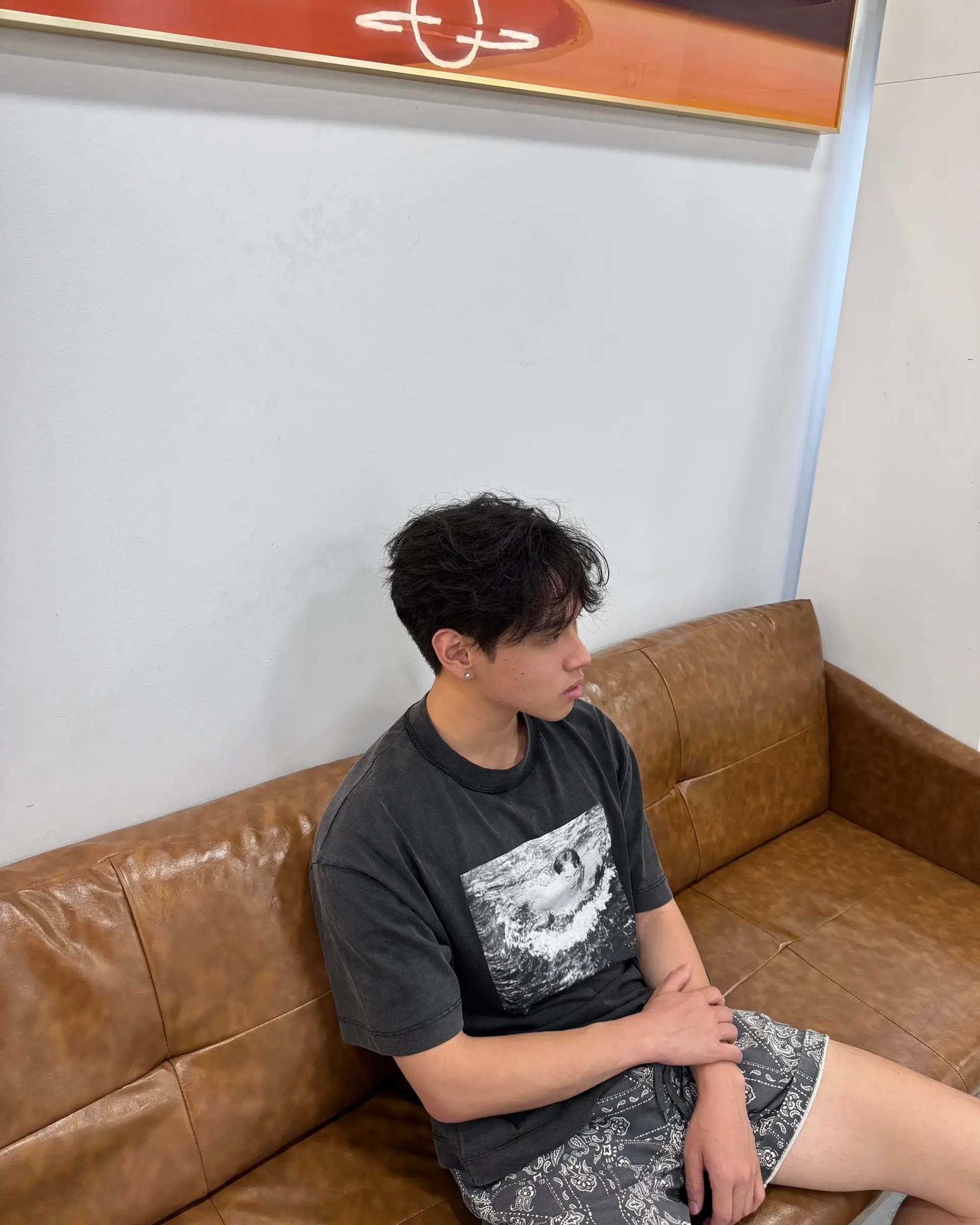 A textured modern mullet with layered, wavy hair. 1