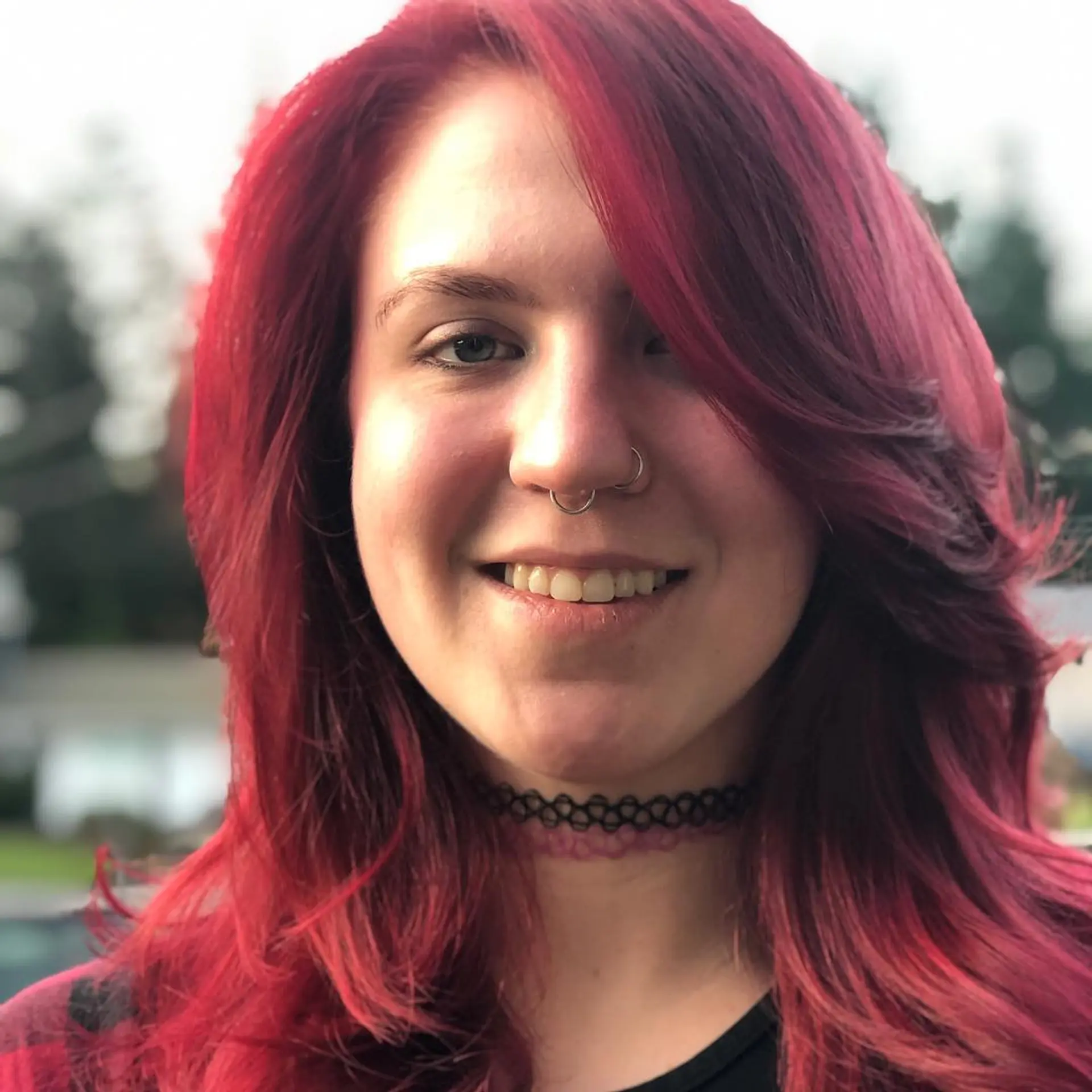 Medium-length vibrant magenta-red hair featuring soft feathered layers and a sweeping side fringe. 1