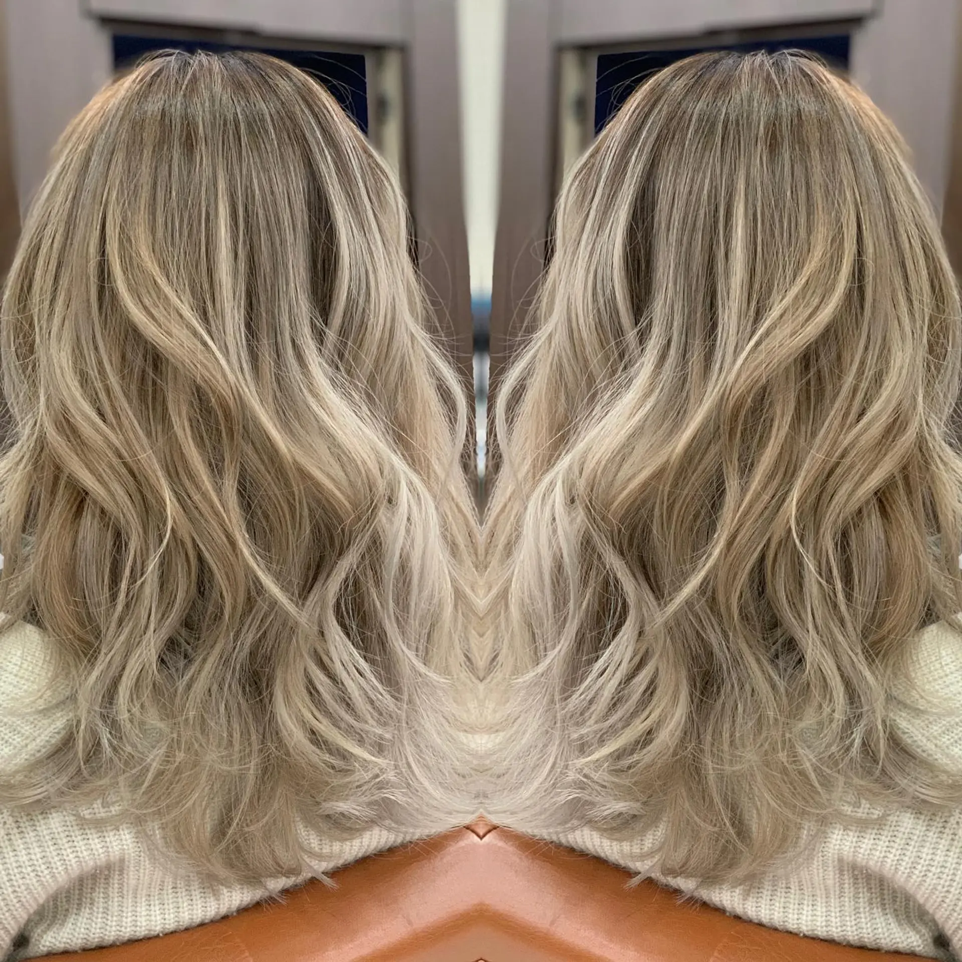 Dimensional ash beige blonde balayage styled with soft, loose waves. 1