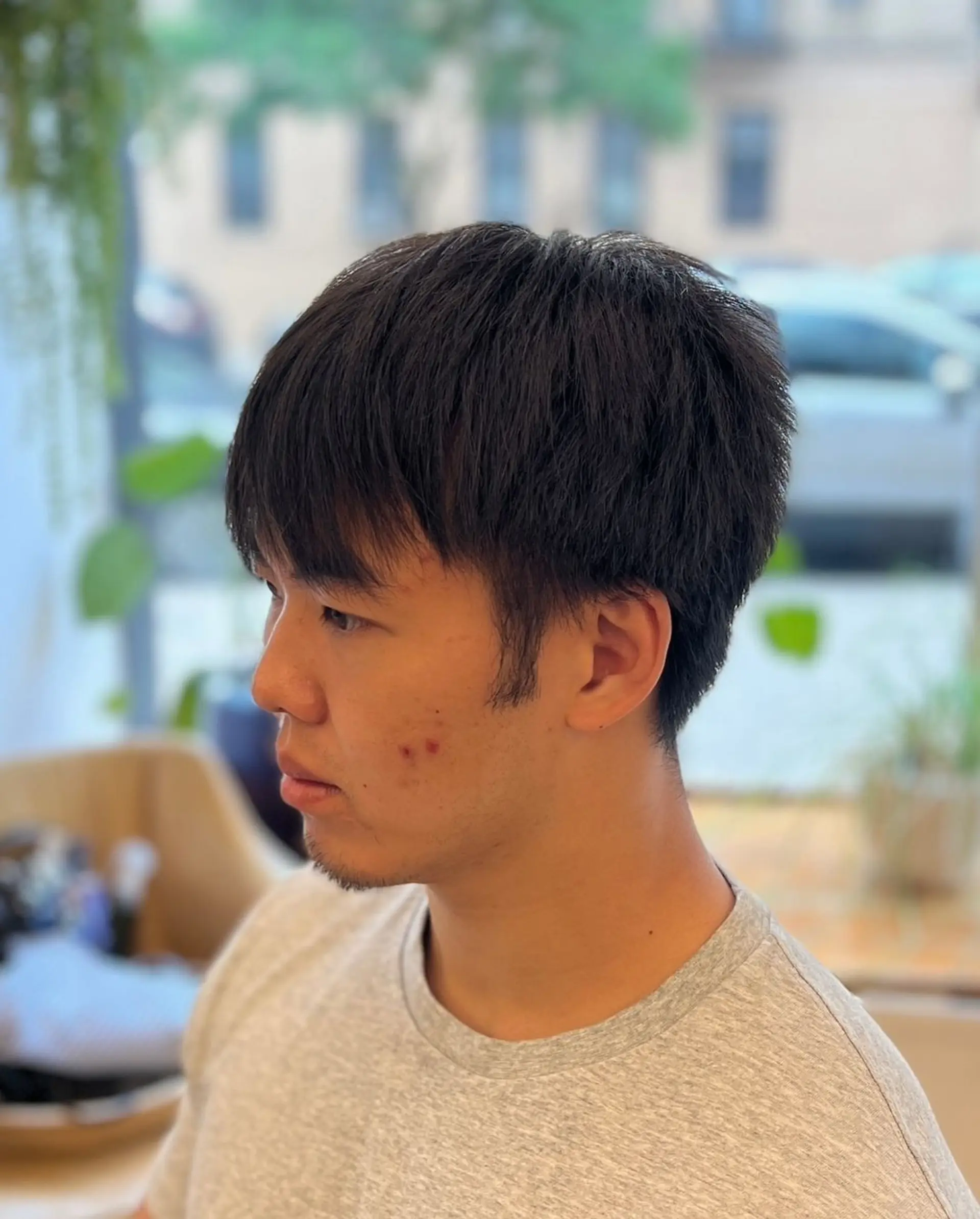 Textured top with natural waves, low fade sides, and short length. 2