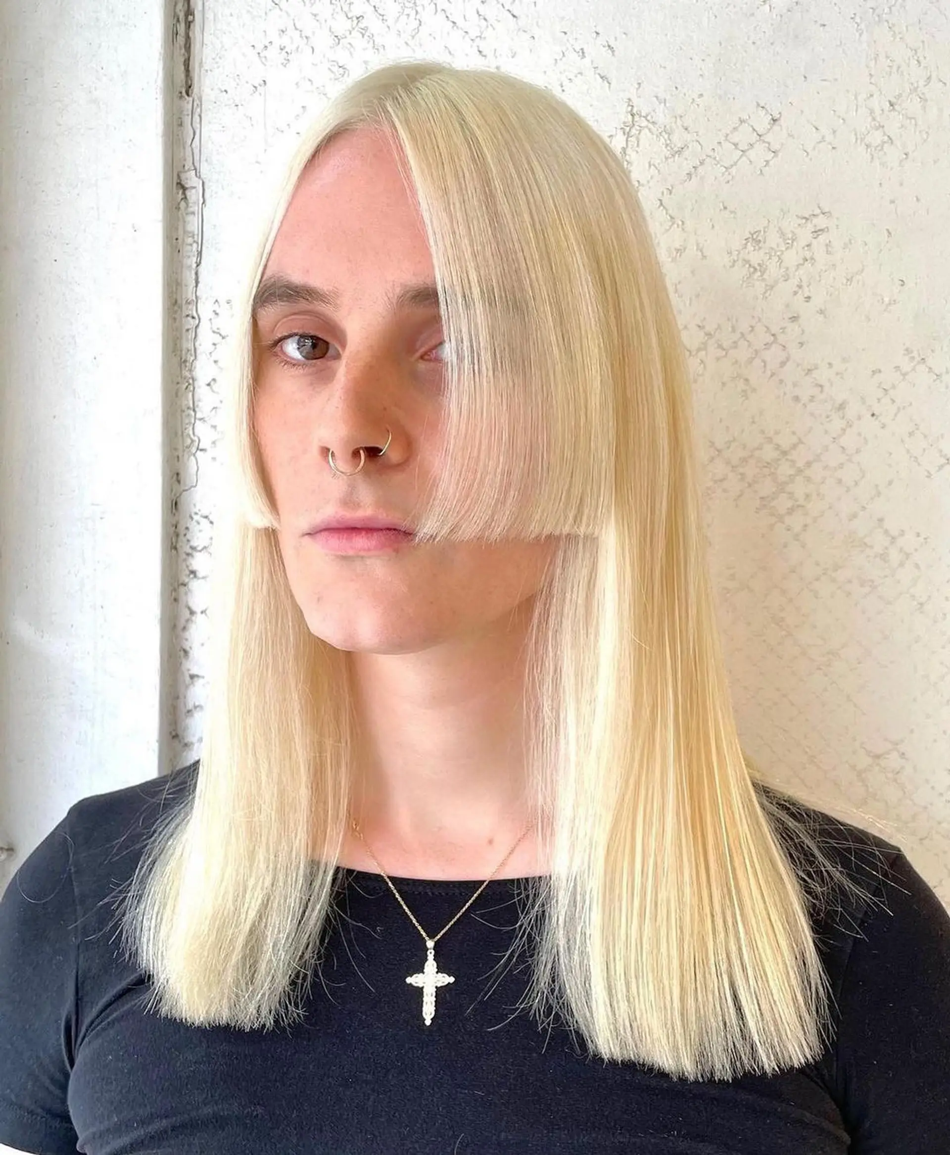A long, sleek platinum blonde hairstyle with blunt bangs and a center part, offering a smooth, curtain-like effect. 1