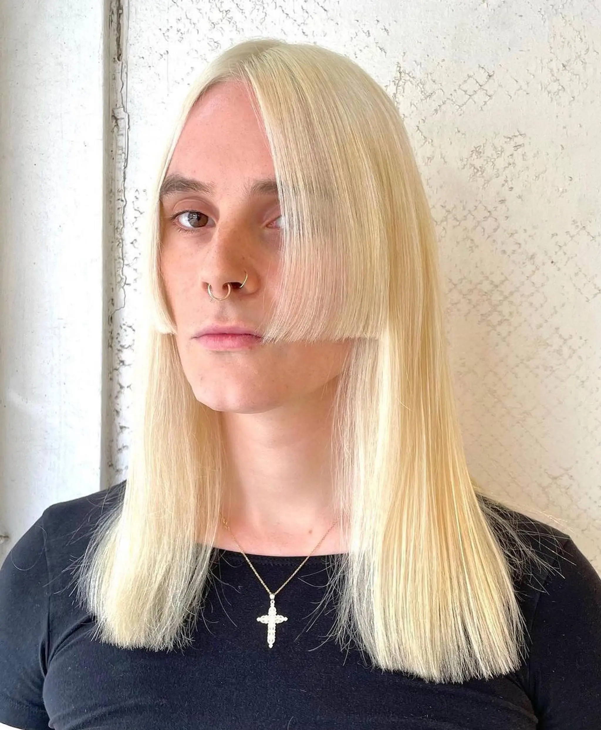 A long, sleek platinum blonde hairstyle with blunt bangs and a center part, offering a smooth, curtain-like effect. 1