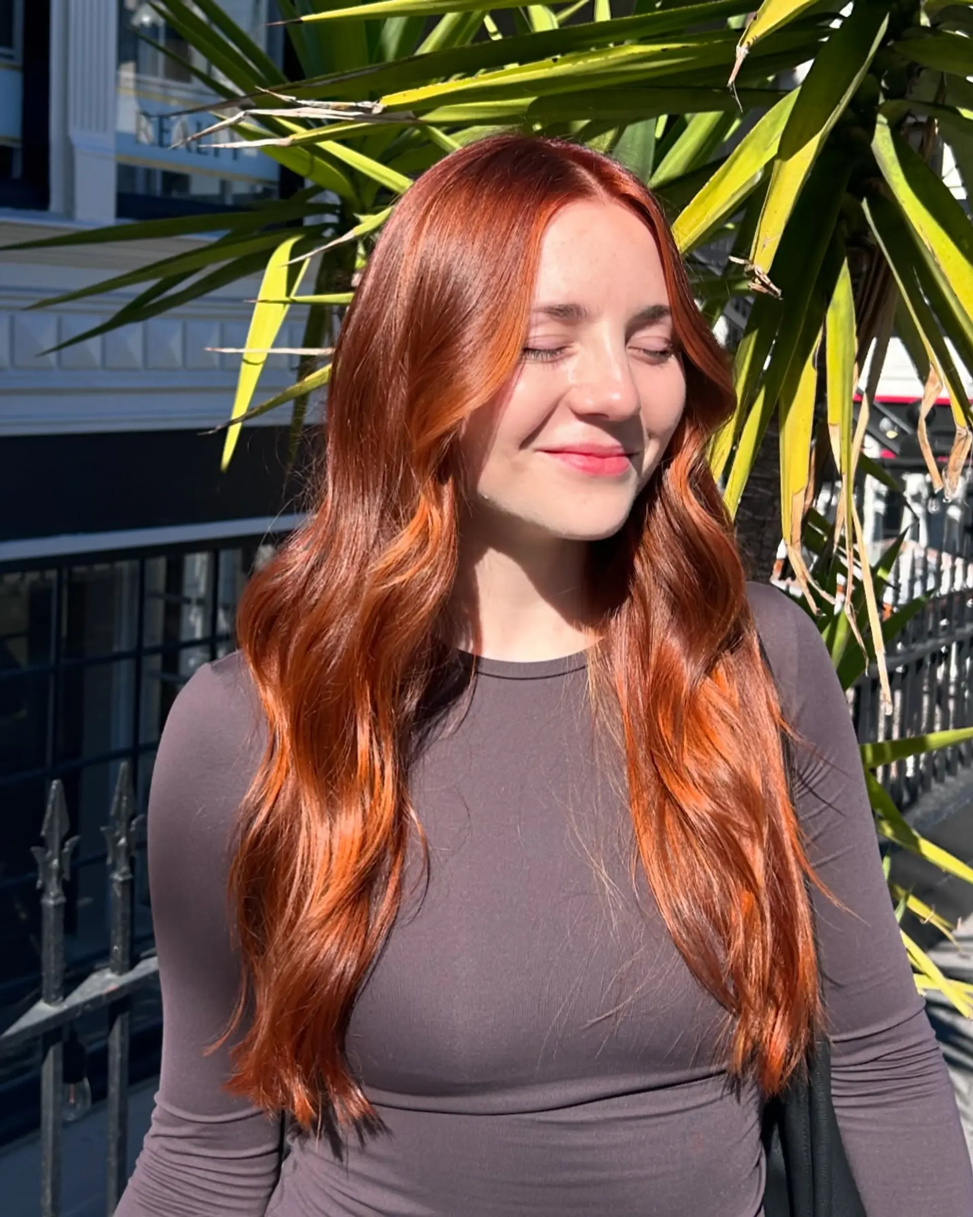 Long, flowing copper red hair styled with soft, dimensional waves and a center part. 1