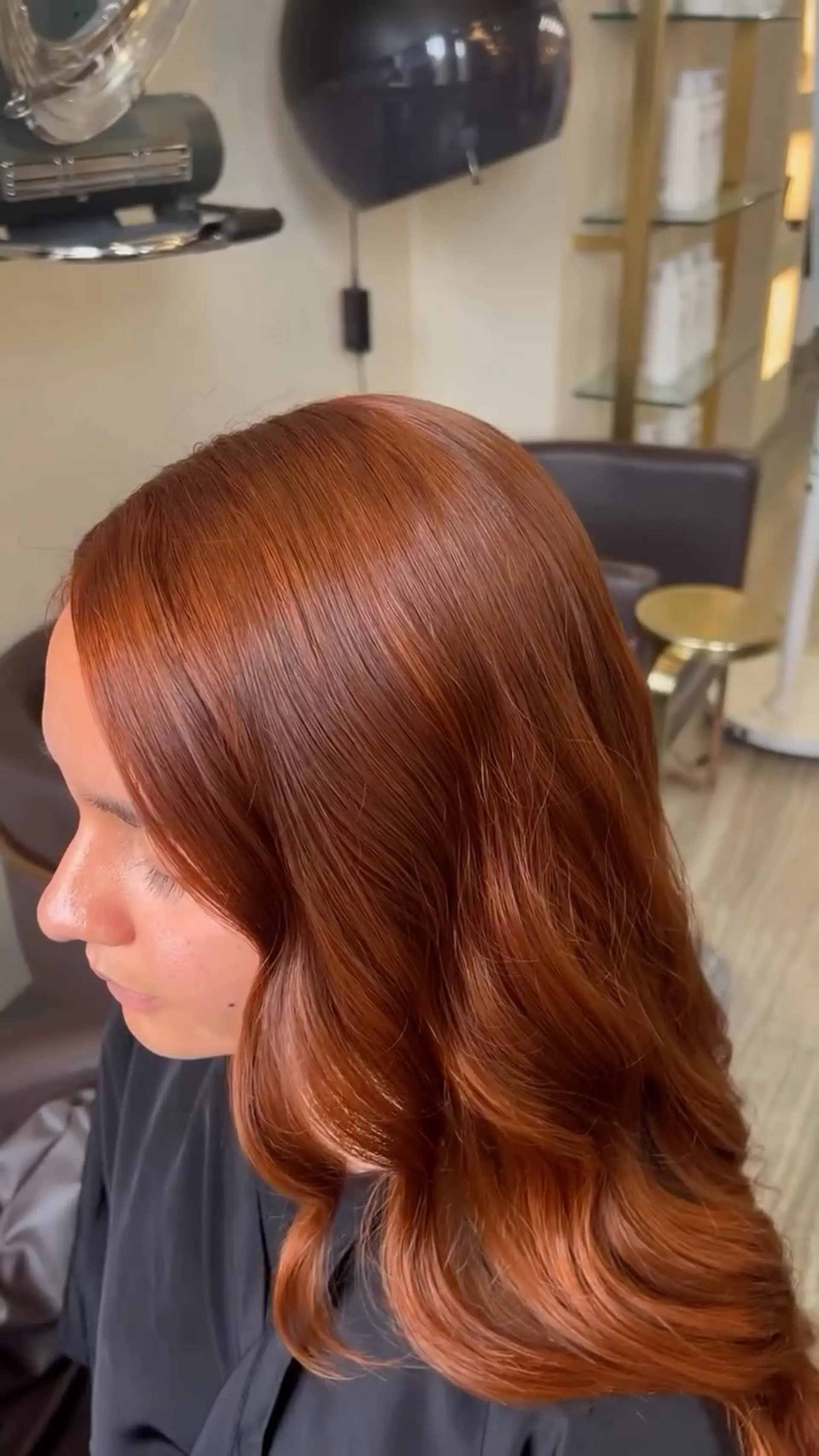 Vibrant copper hair styled into polished, soft romantic waves with a radiant shine. 1