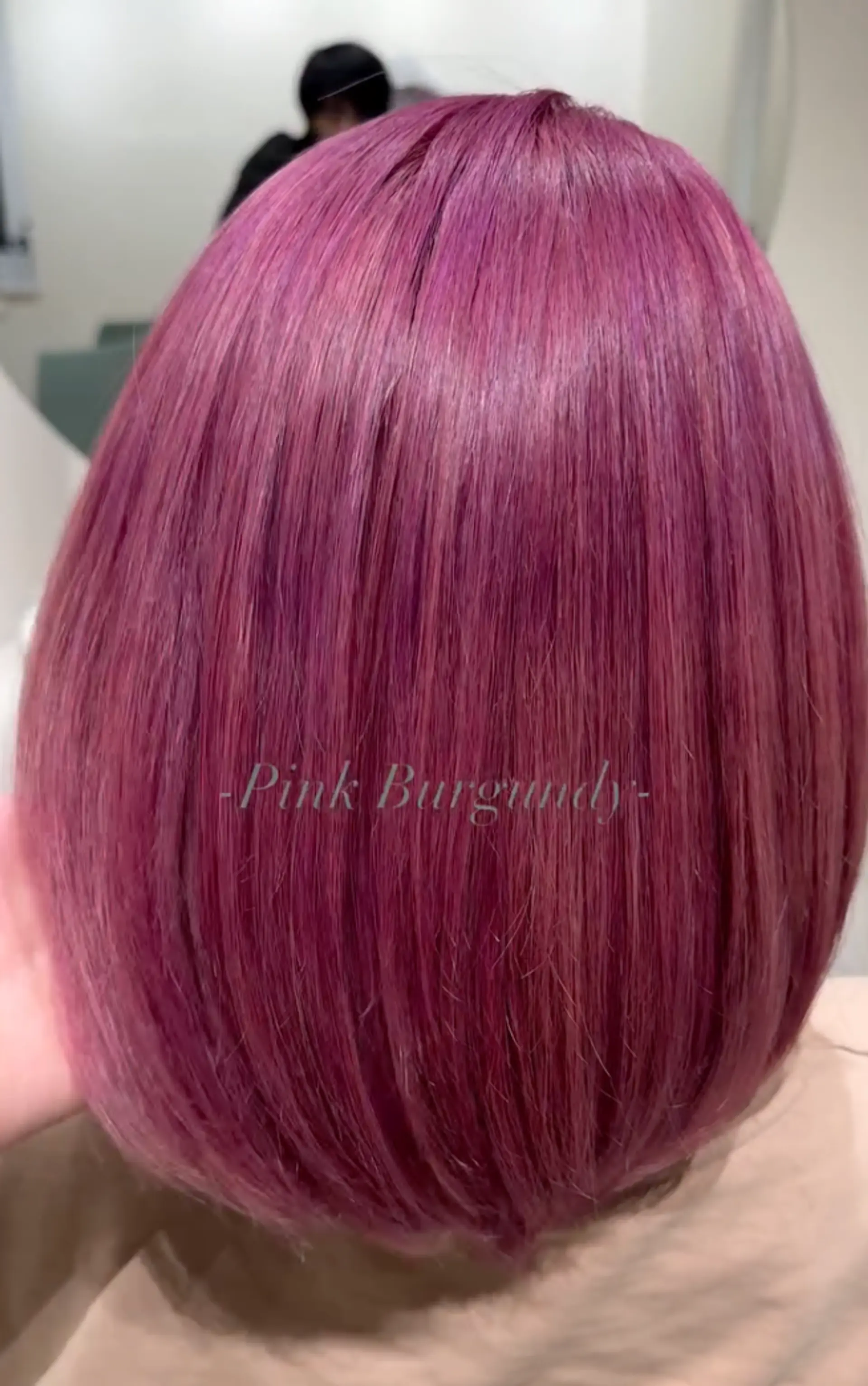 Sleek and straight classic bob with a blunt cut, featuring a vibrant mix of pink and purple colors. Short length above the shoulders. 1