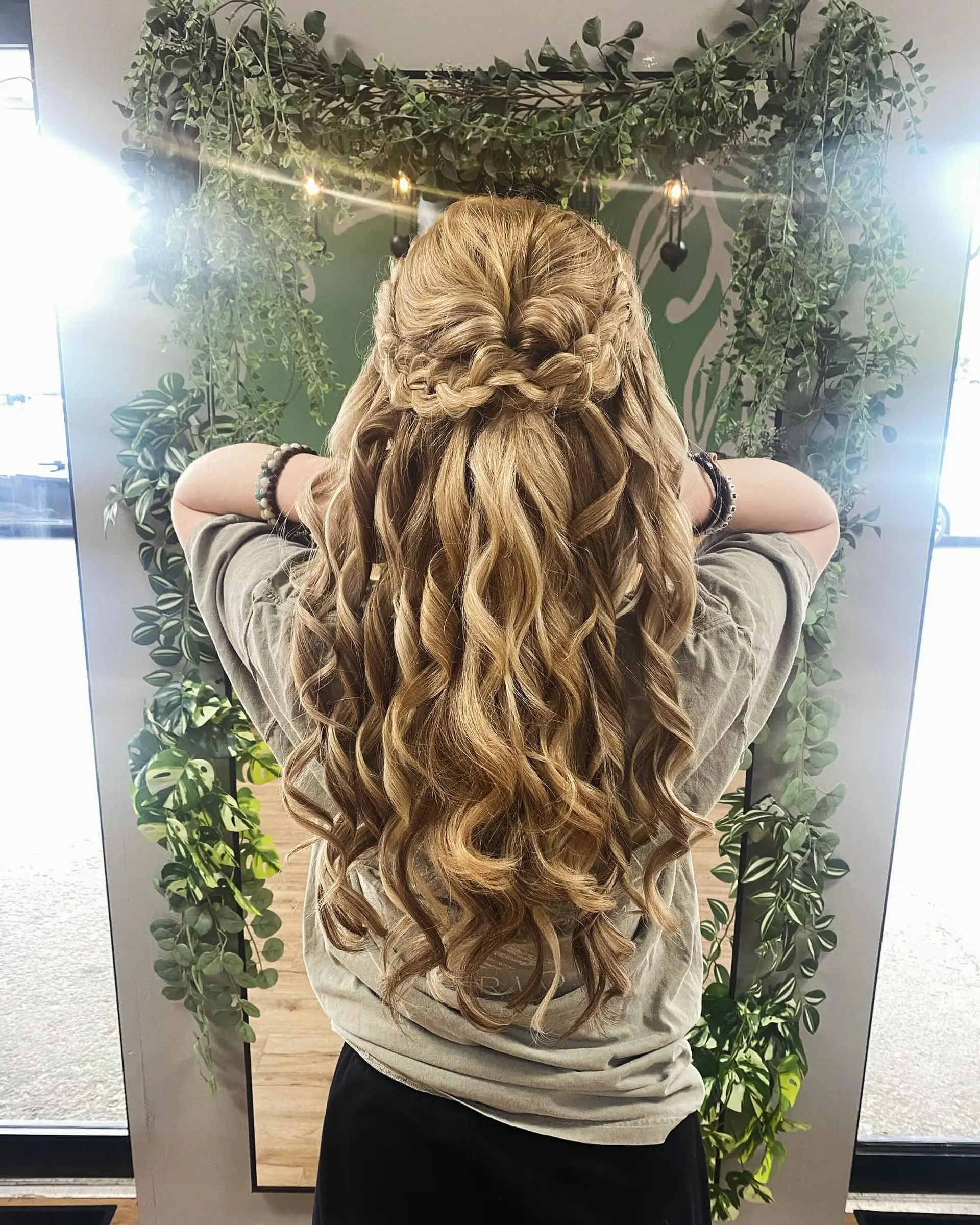 A romantic half-up hairstyle featuring textured crown braids and long, cascading curls. 1