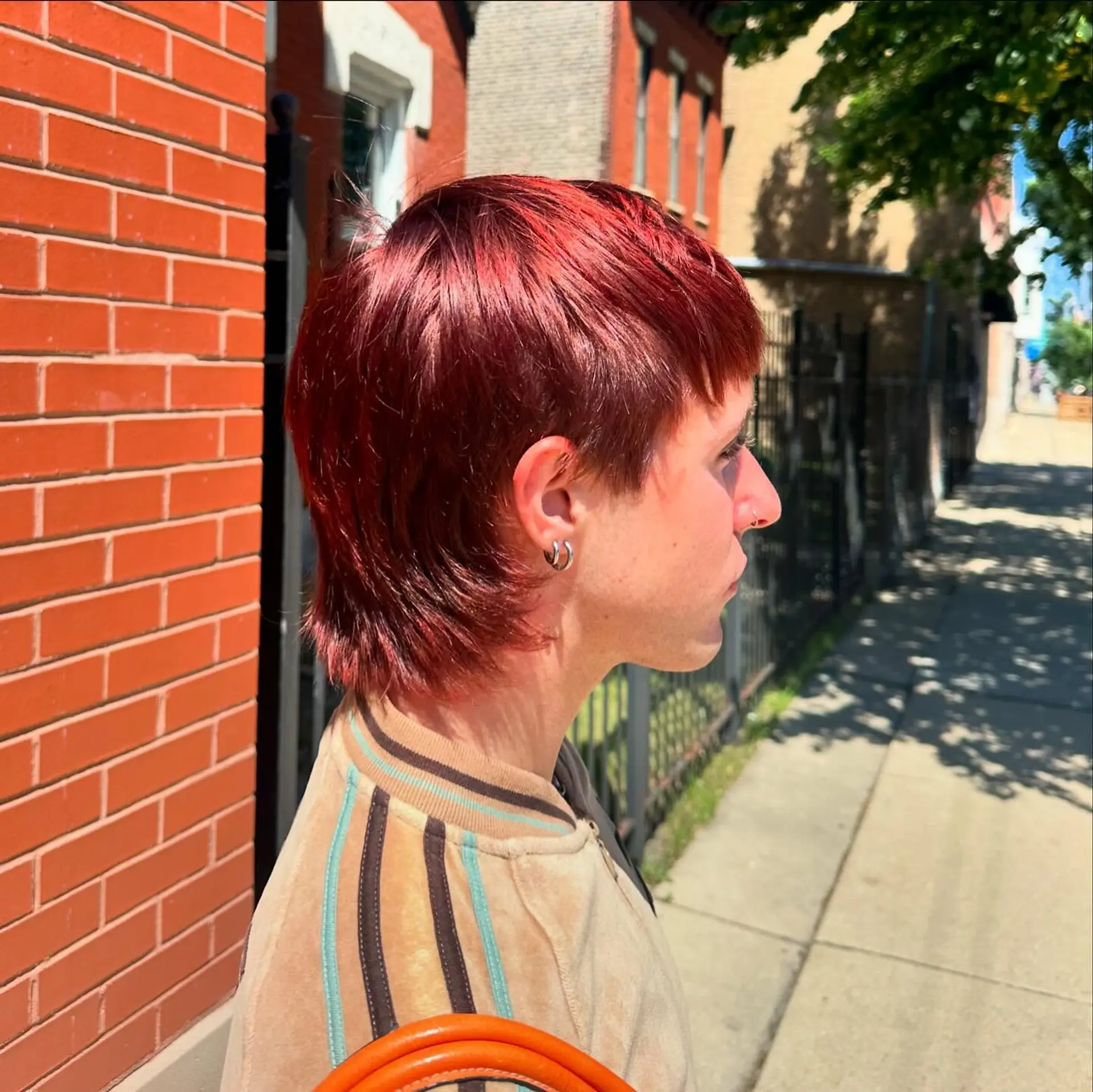 A short, modern mullet with choppy layers and a textured finish. 1