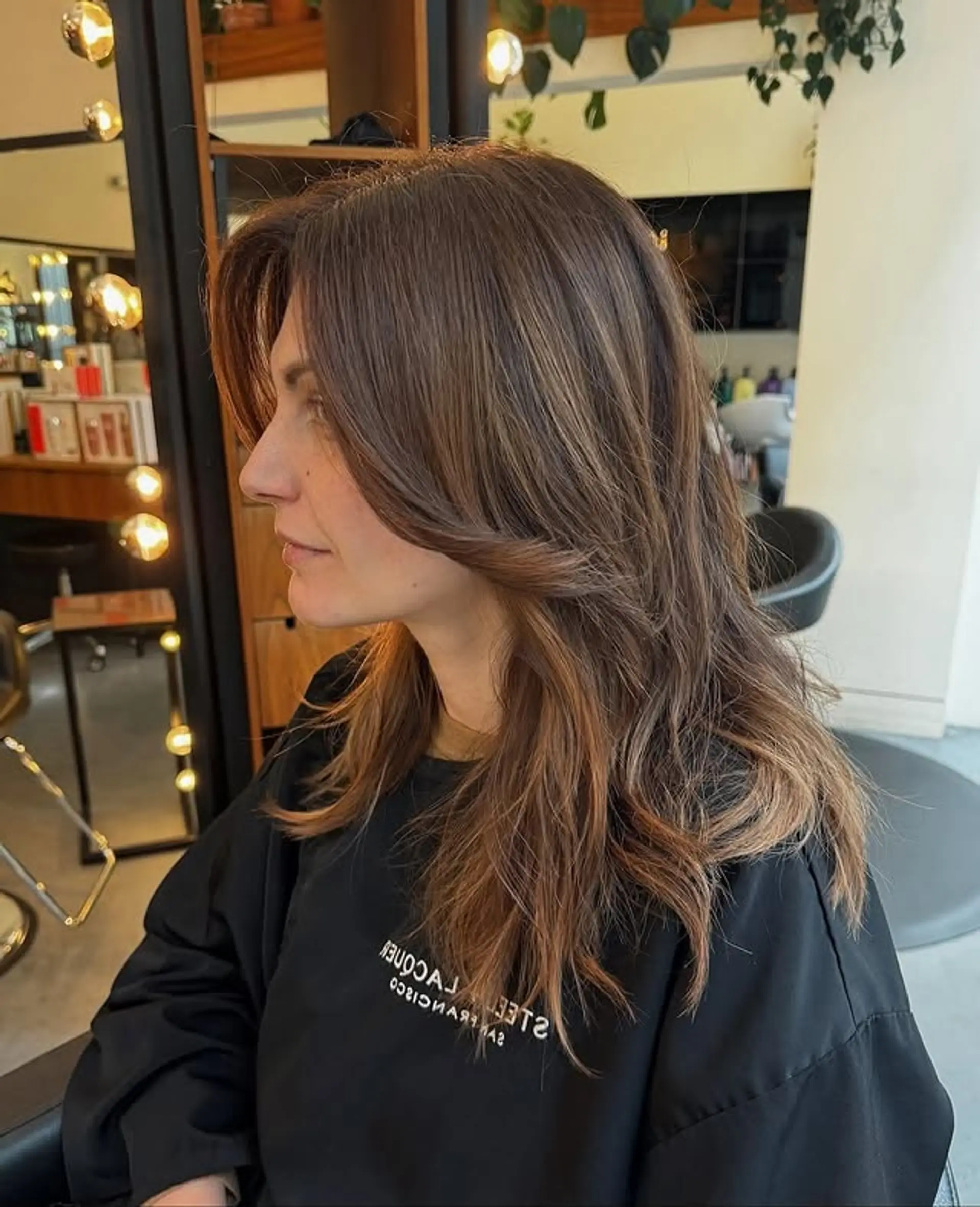 A layered shag haircut with face-framing layers and wispy curtain bangs. 1