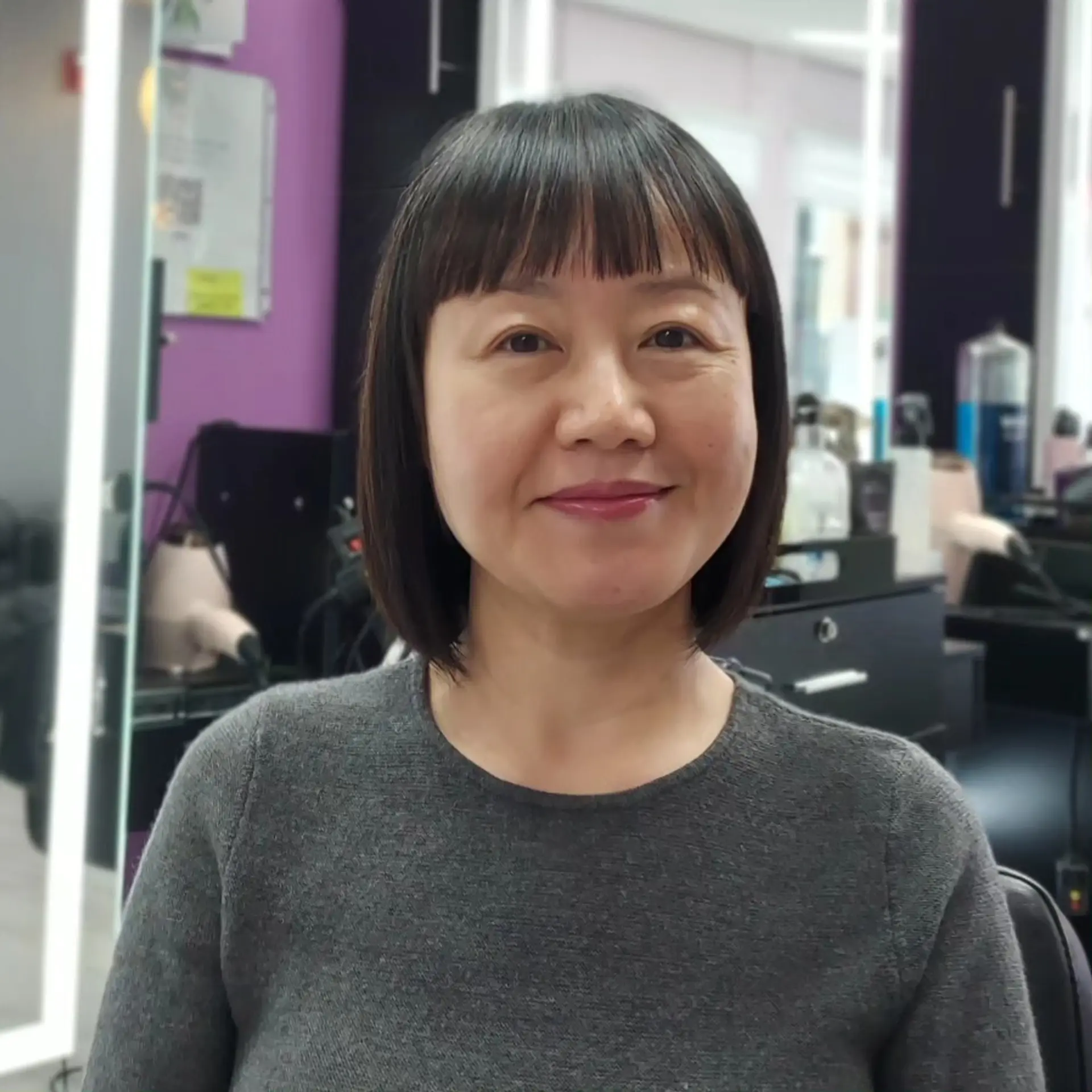 A sleek, chin-length classic bob paired with straight-across blunt bangs. 1