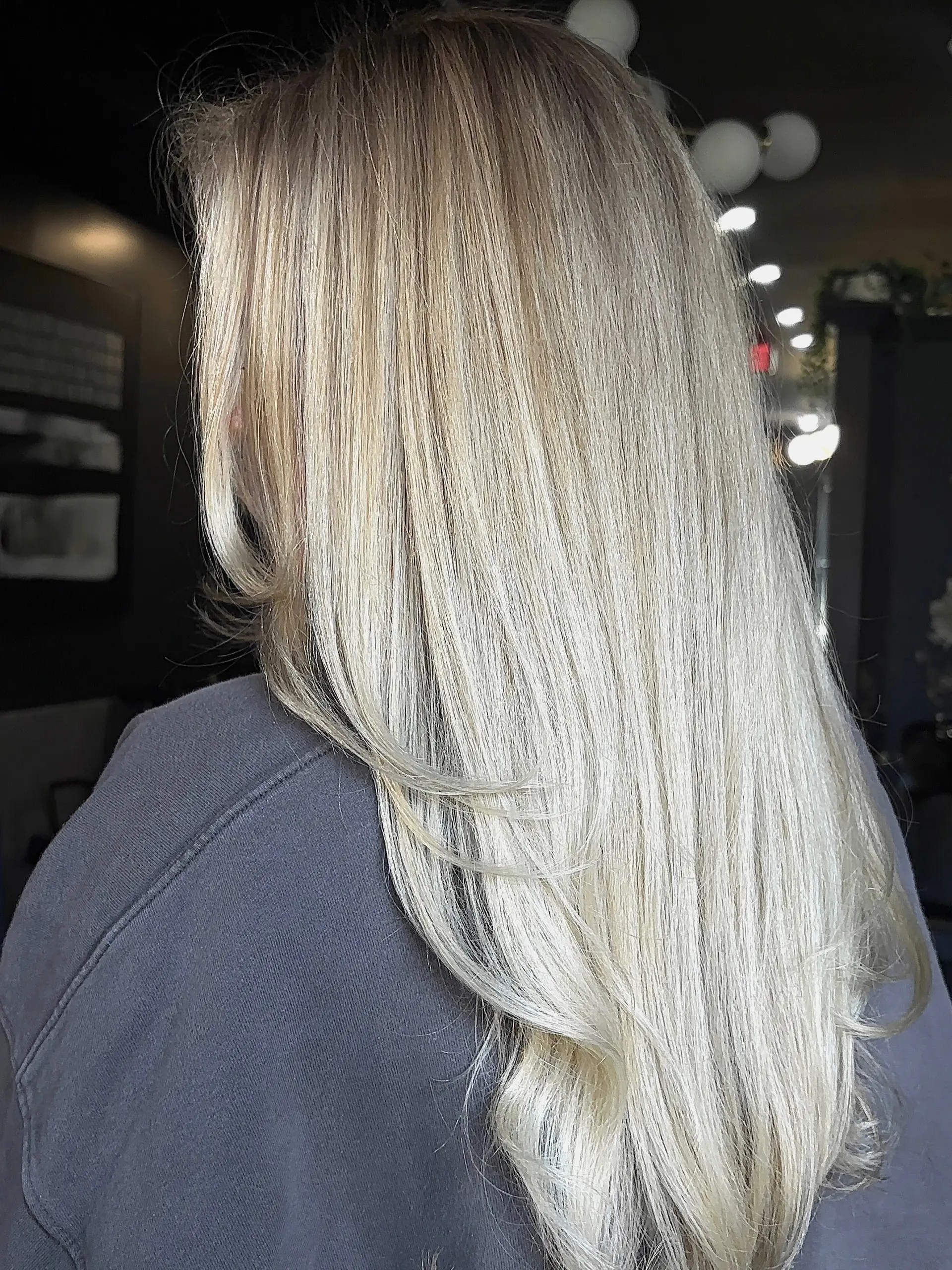 Long, multi-dimensional bright blonde hair cut in soft layers with a smooth blowout. 1