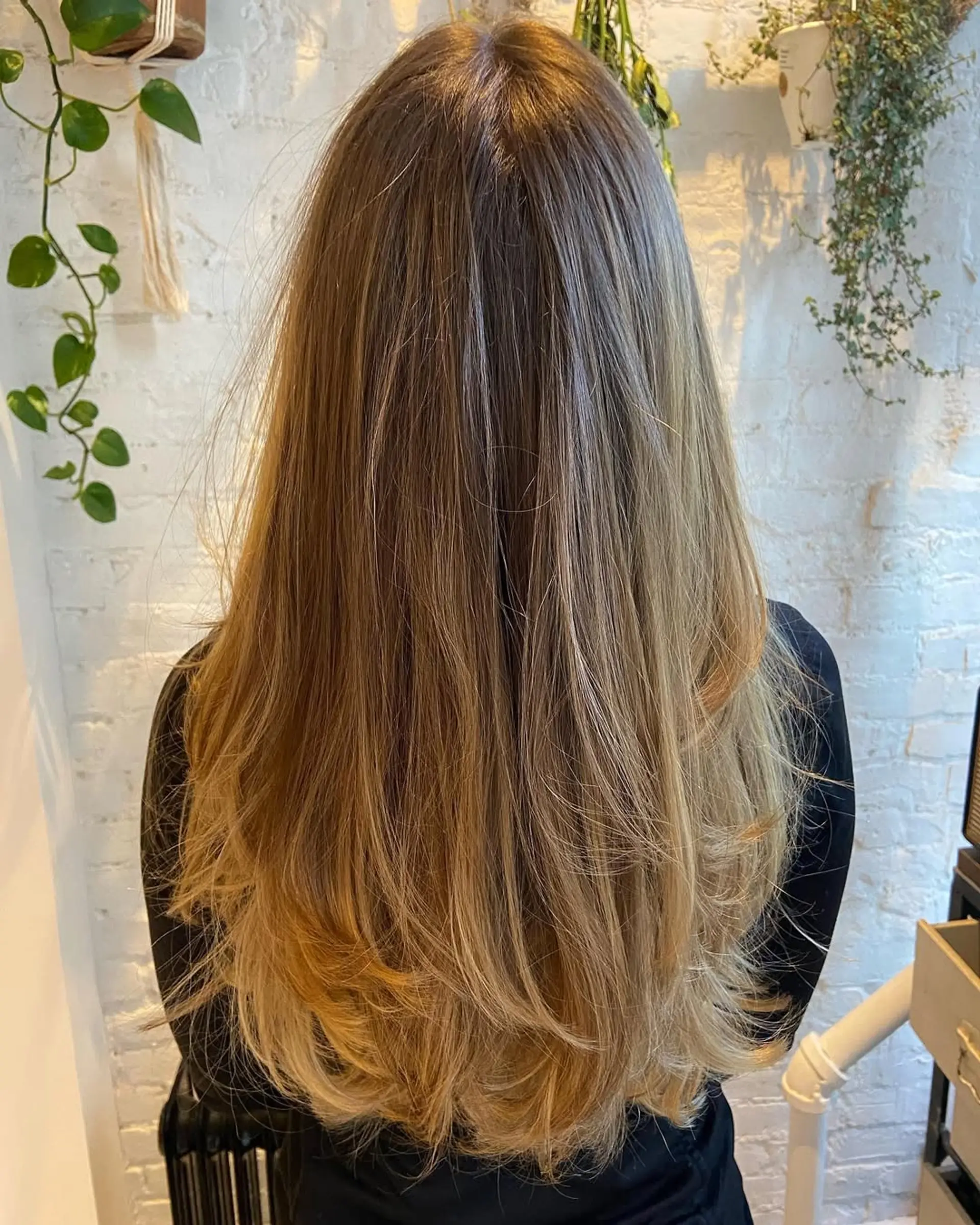 Long layered hairstyle with honey blonde balayage. 1